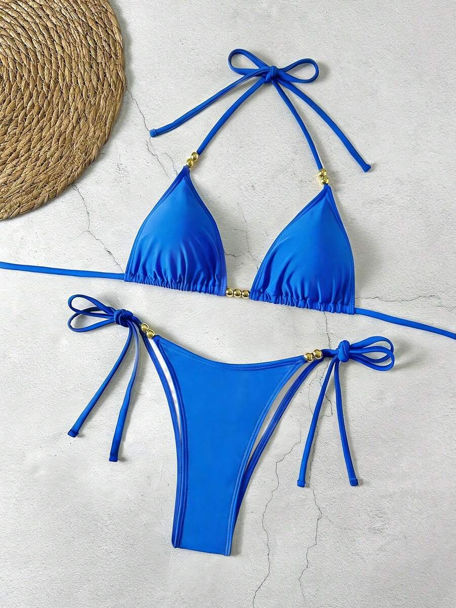 Women's black halter bikini set featuring triangle cups with gold bead decor and tie-back closure