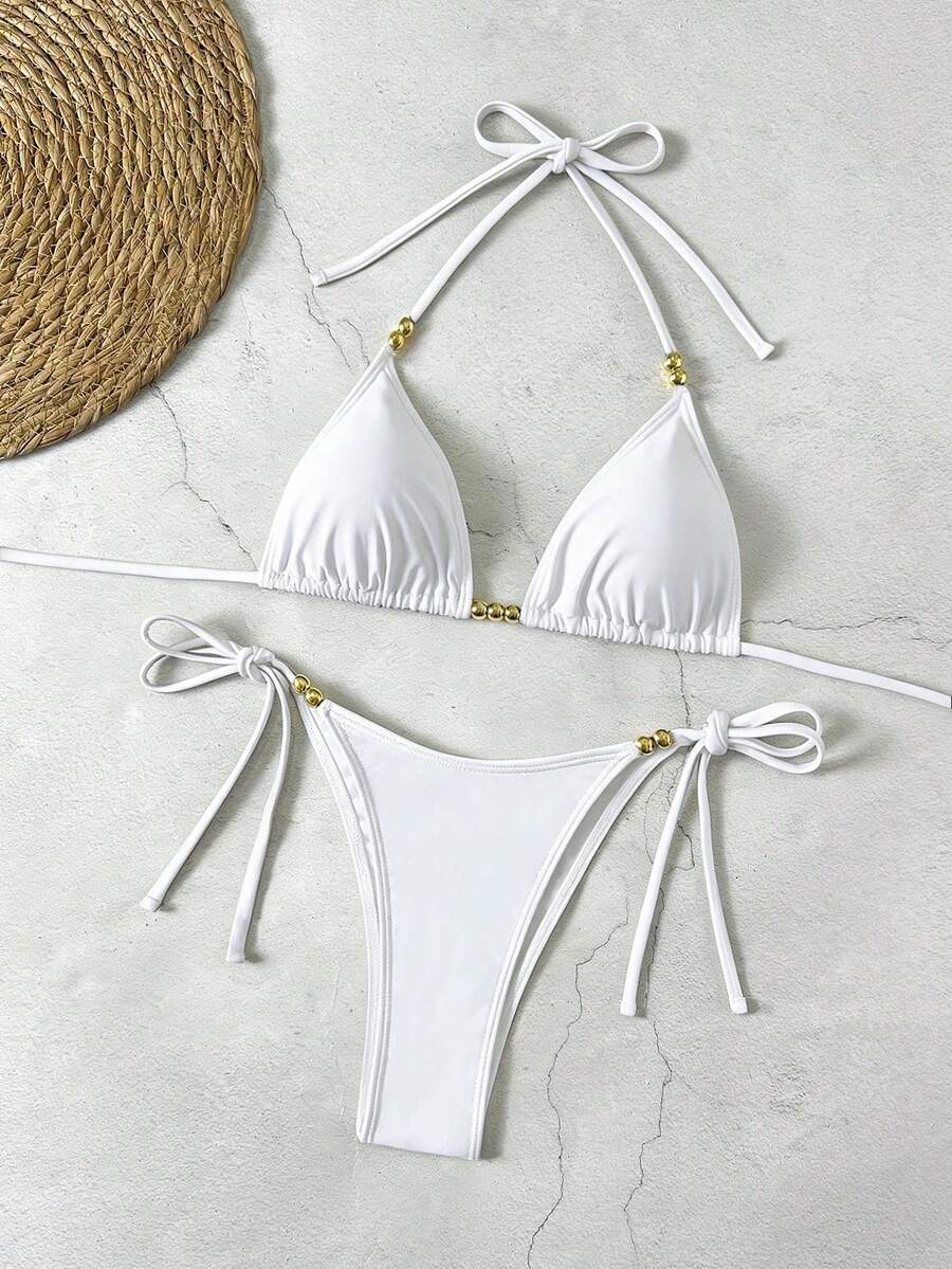 Women's black halter bikini set featuring triangle cups with gold bead decor and tie-back closure