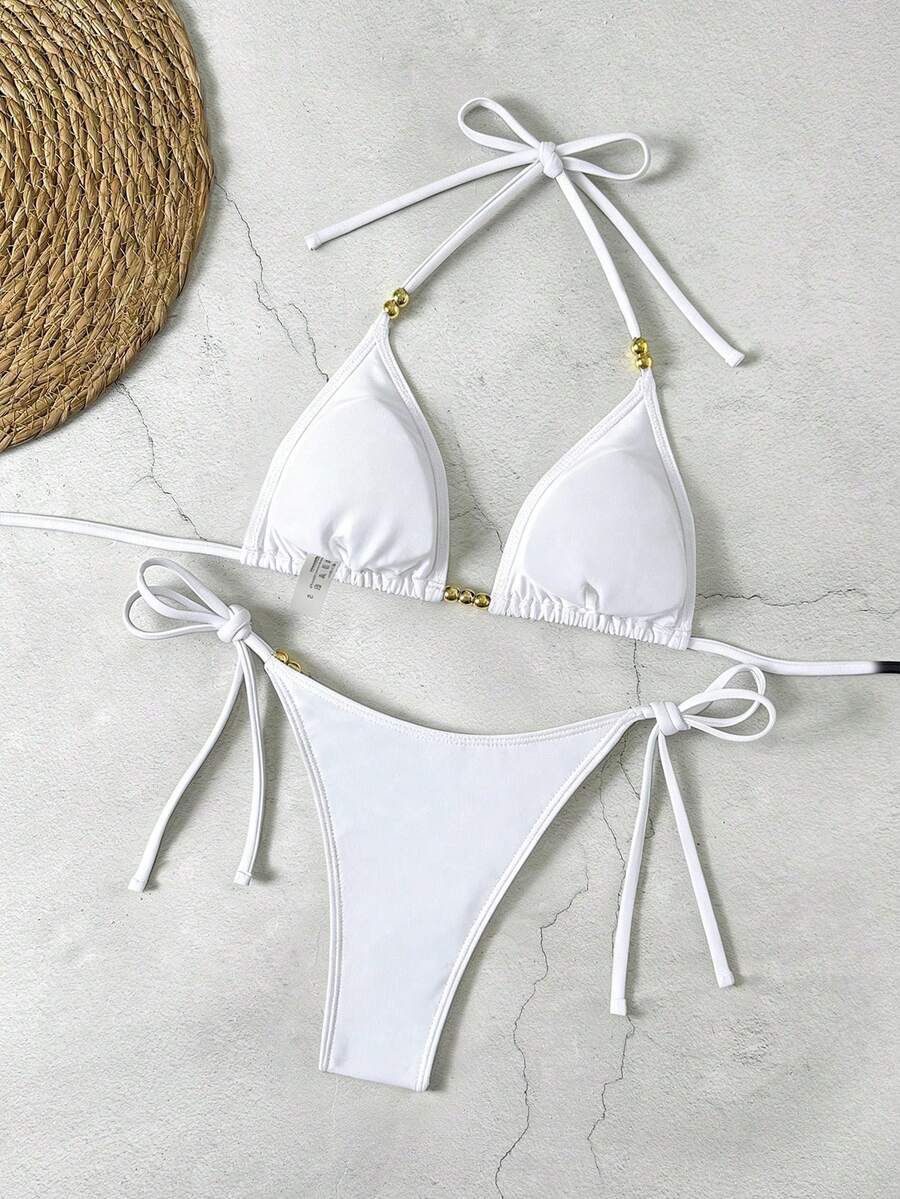 Women's black halter bikini set featuring triangle cups with gold bead decor and tie-back closure