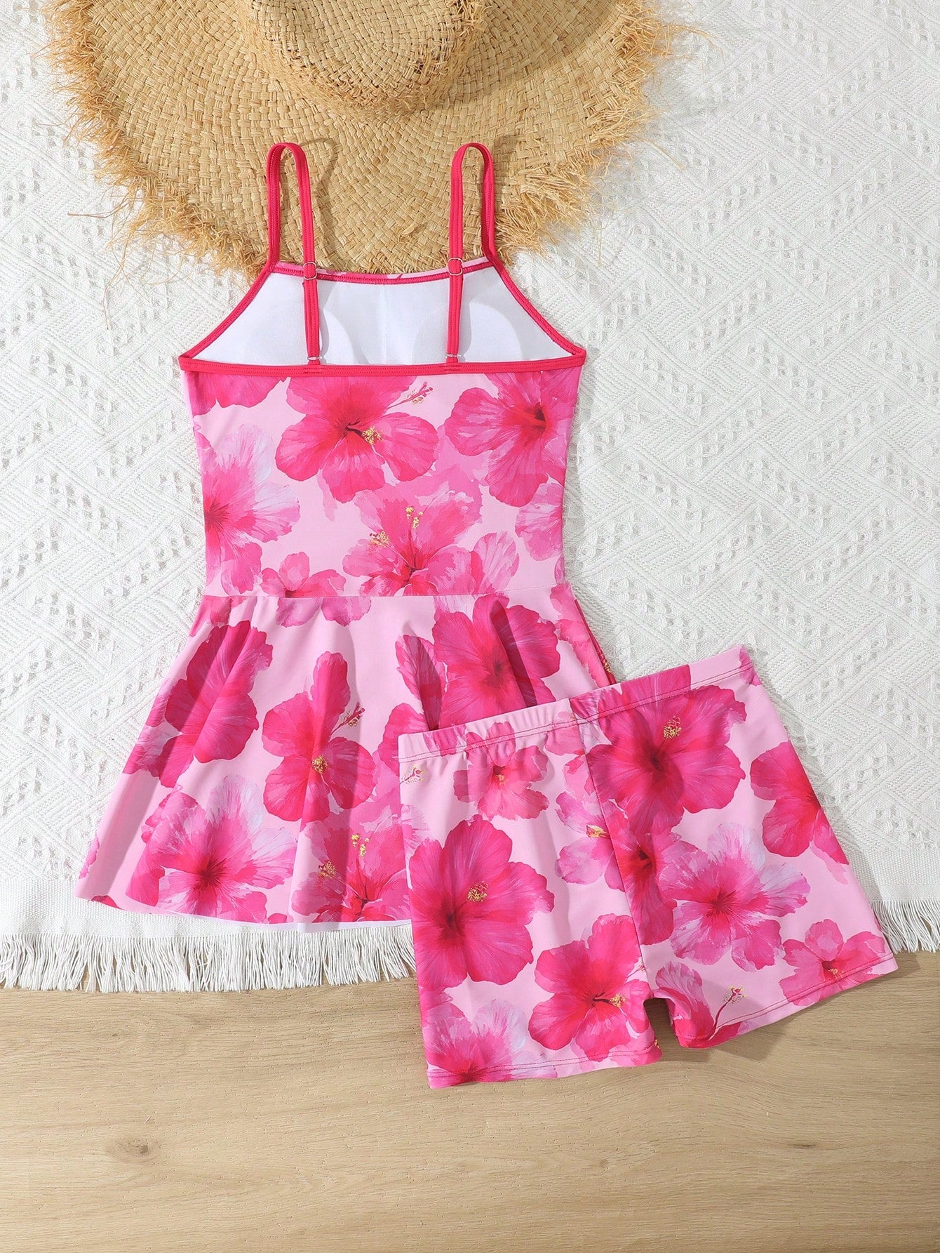 Tween girls black two-piece tankini swimwear set featuring a spaghetti strap sleeveless top with cutout detail and contrast piping, paired with short swim shorts.