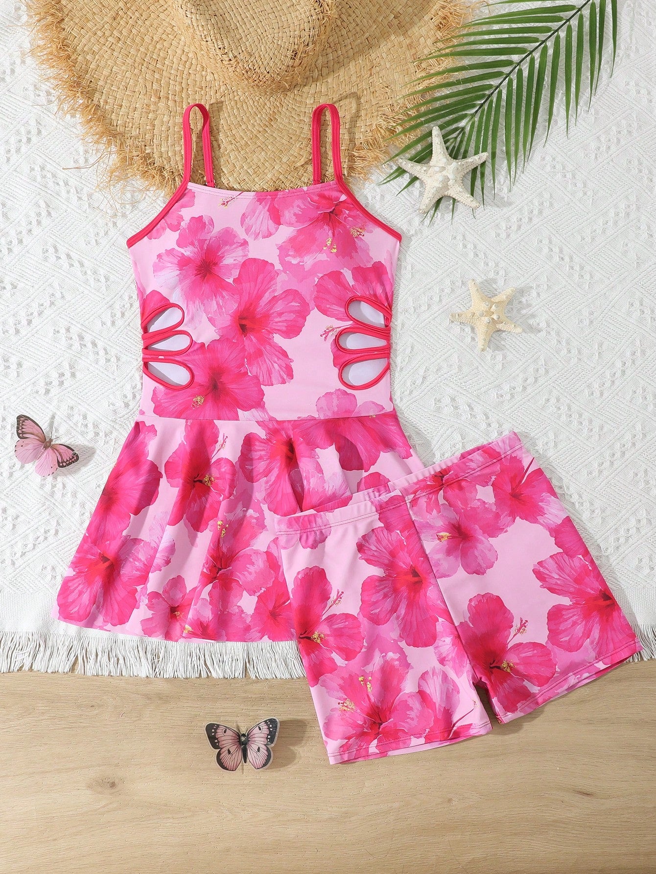 Tween girls black two-piece tankini swimwear set featuring a spaghetti strap sleeveless top with cutout detail and contrast piping, paired with short swim shorts.