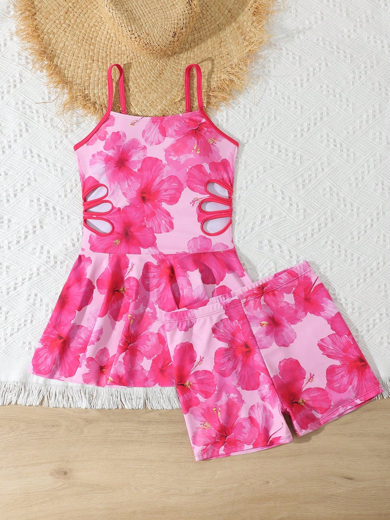 Tween girls black two-piece tankini swimwear set featuring a spaghetti strap sleeveless top with cutout detail and contrast piping, paired with short swim shorts.