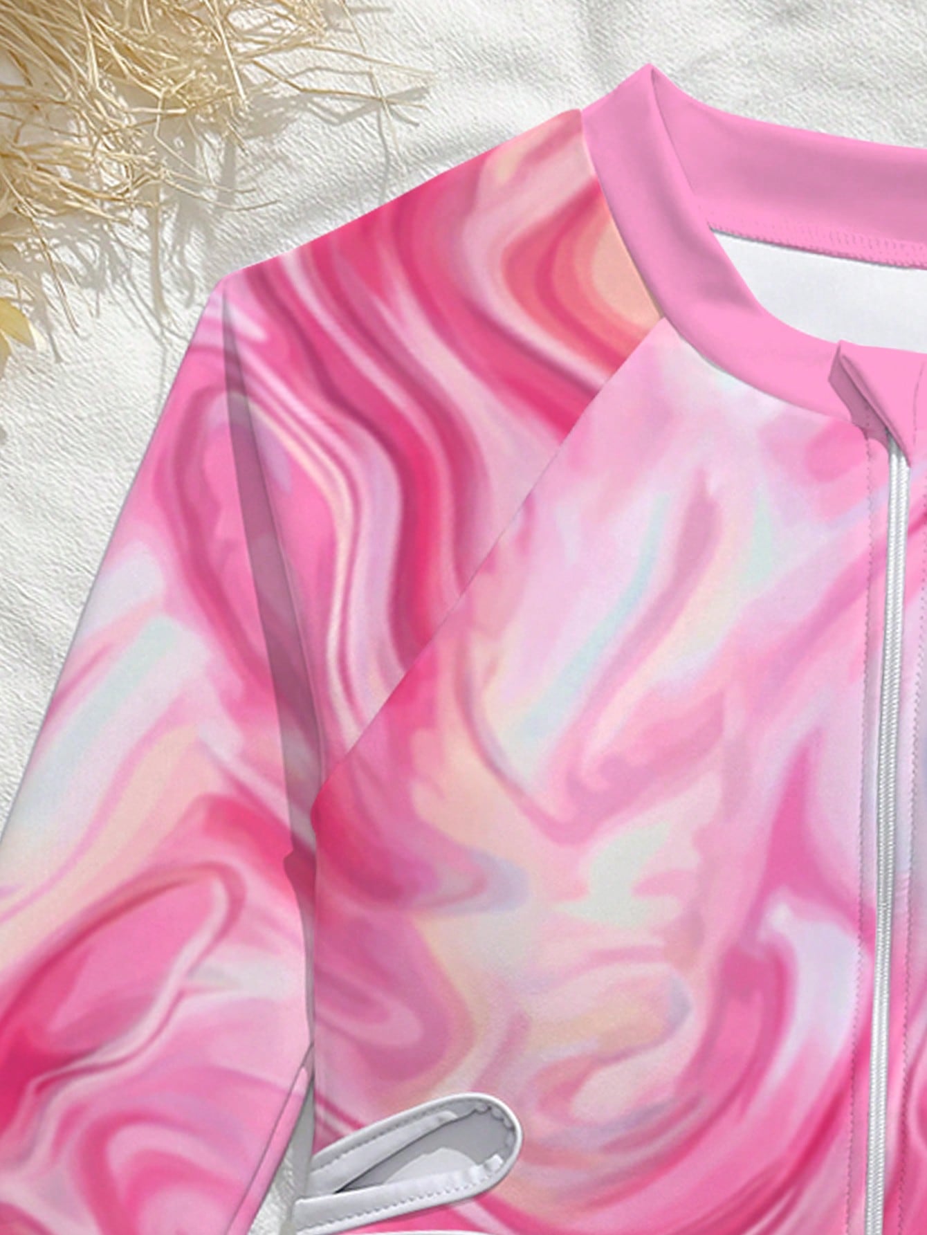 Tween girls one-piece rash guard swimsuit with long sleeves, high neck, front zipper, and ocean shell graphic print in a fitted style for beach, swimming, and vacation wear.