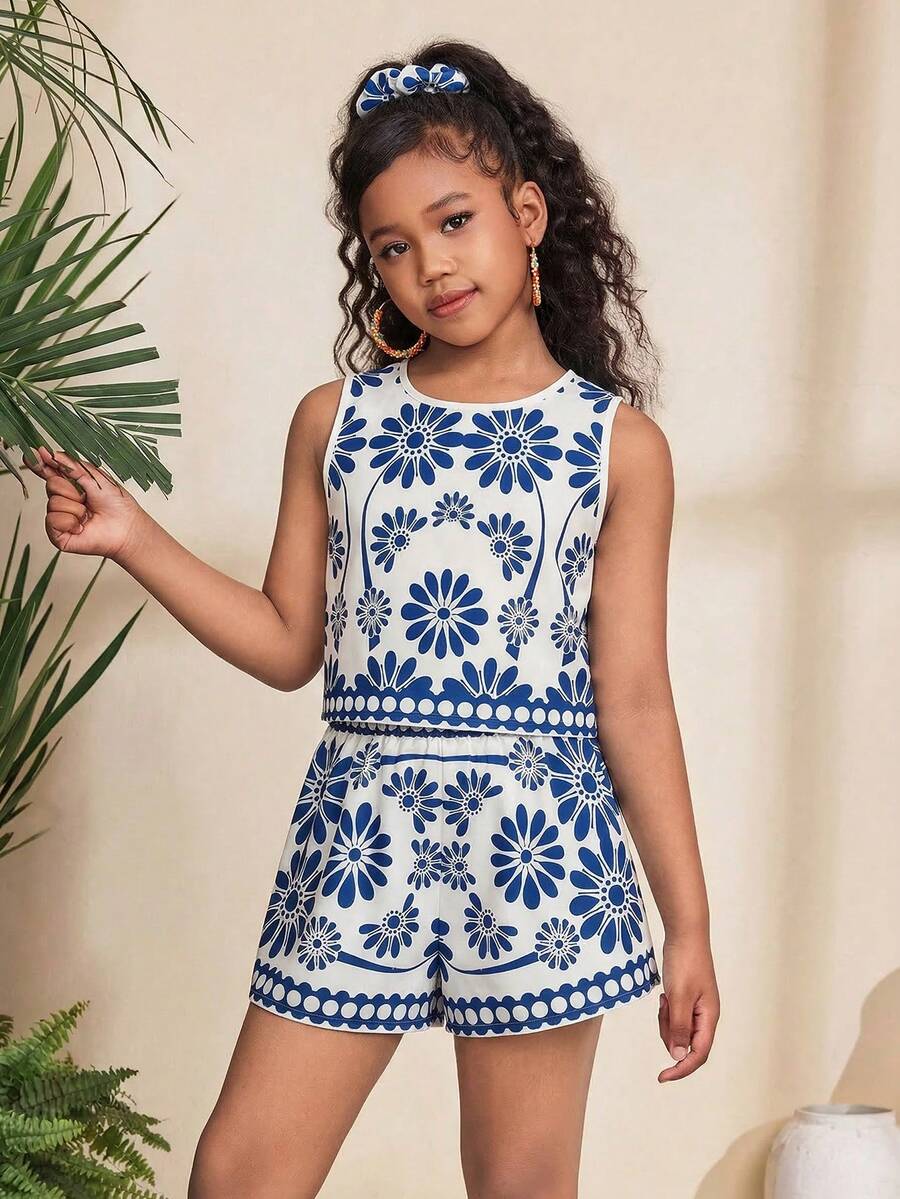Tween girl wearing a tropical floral print two-piece vacation set featuring a sleeveless round neck tank top with button details and matching shorts.