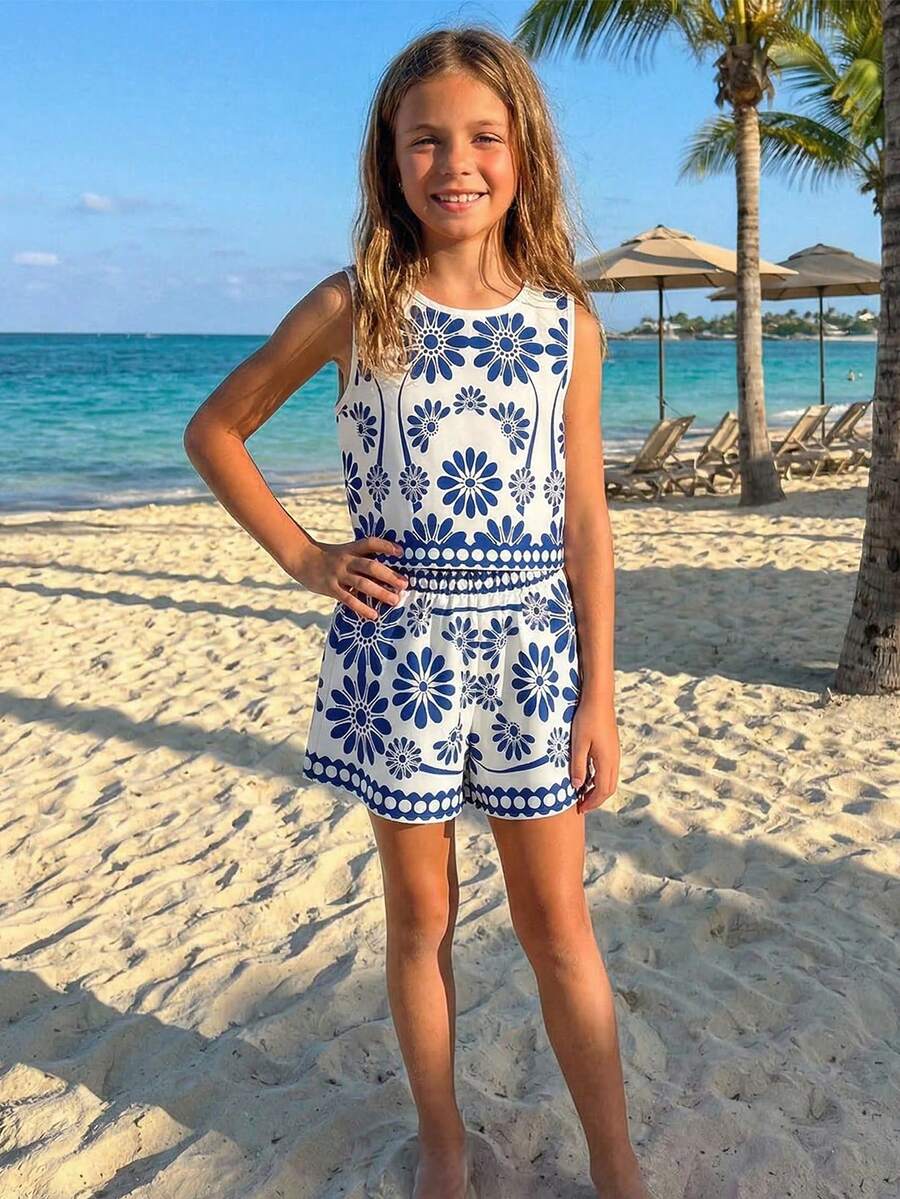 Tween girl wearing a tropical floral print two-piece vacation set featuring a sleeveless round neck tank top with button details and matching shorts.