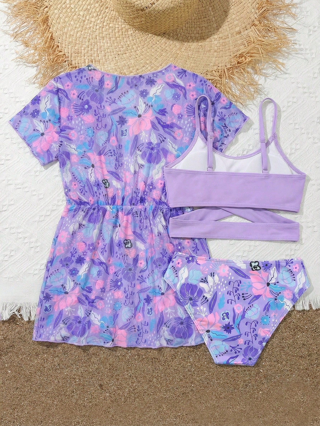 Three-piece tween girls swimwear set with a floral print, featuring a criss-cross bikini top, regular bikini bottoms, and a kimono cover-up in assorted prints.