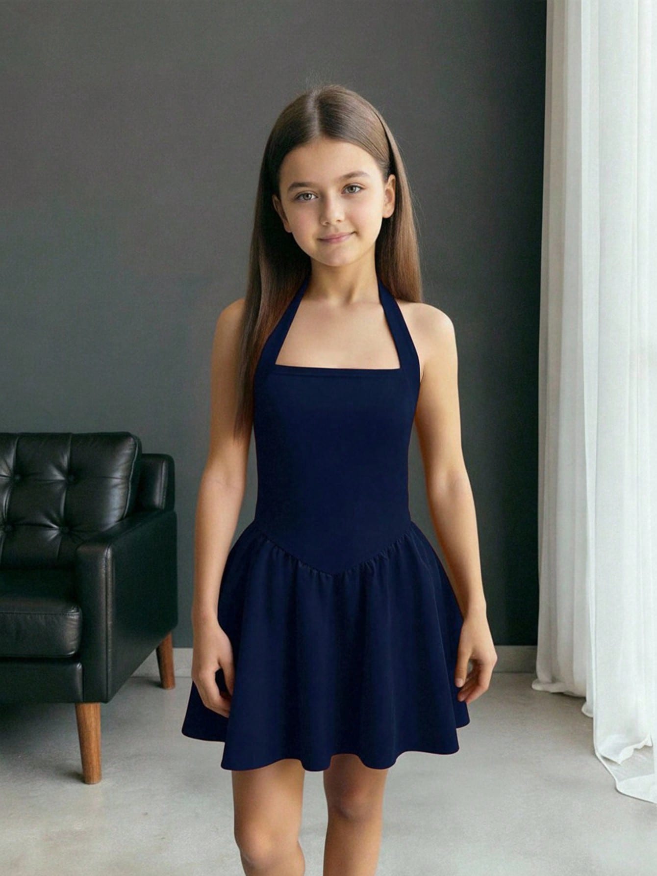 Black sleeveless halter polka dot mini dress for tween girls featuring a high waist and flared hem