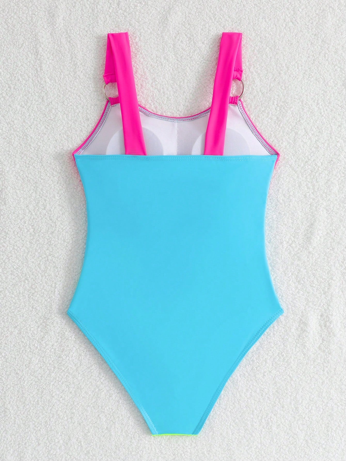 Black one-piece swimsuit for tween girls with cut out detail, spaghetti straps, high waist bottom, wireless bra, and fitted vacation swimwear style.