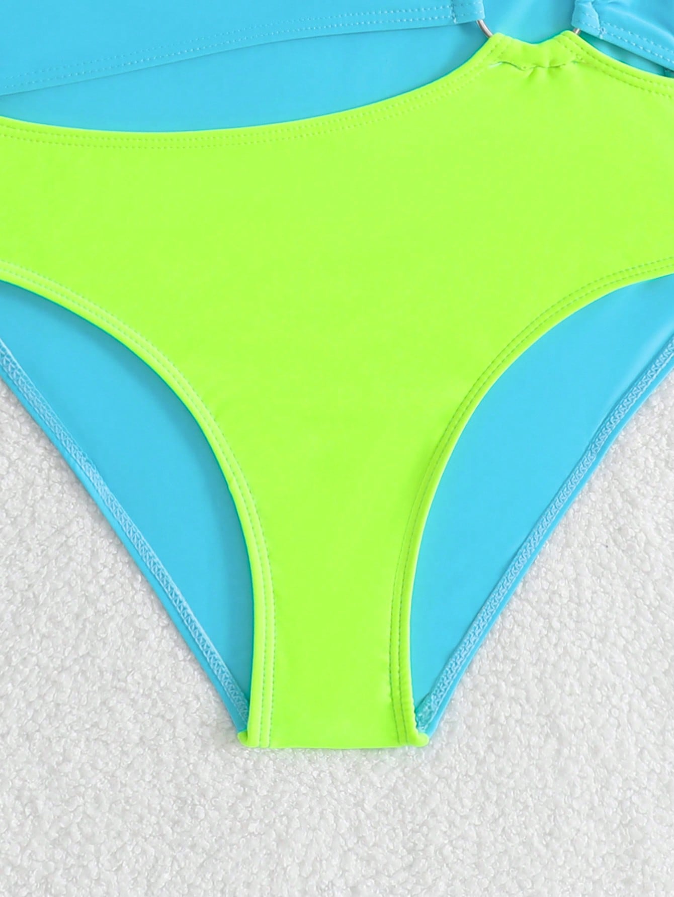Black one-piece swimsuit for tween girls with cut out detail, spaghetti straps, high waist bottom, wireless bra, and fitted vacation swimwear style.