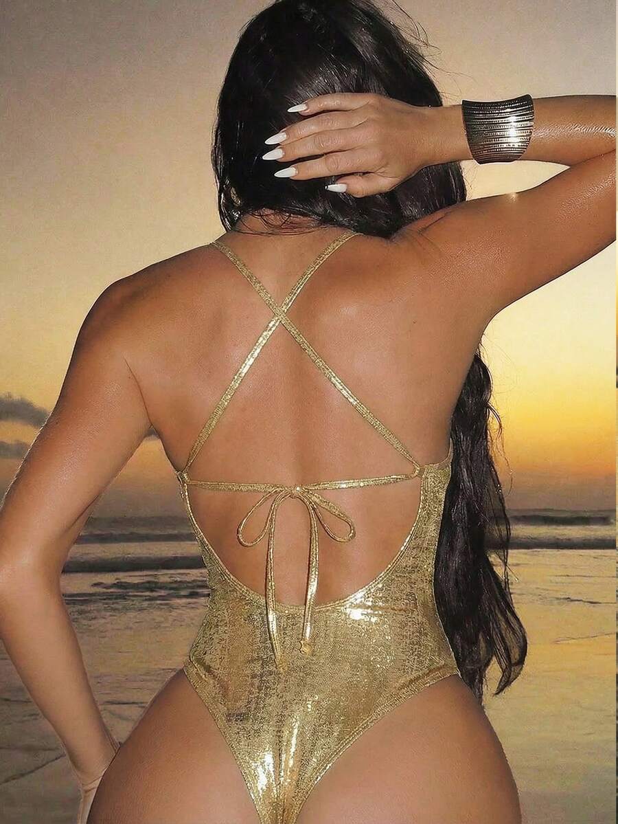Women's black lace one-piece swimsuit featuring a deep V-neckline, spaghetti straps, backless tie-up detail, and thong bottom.