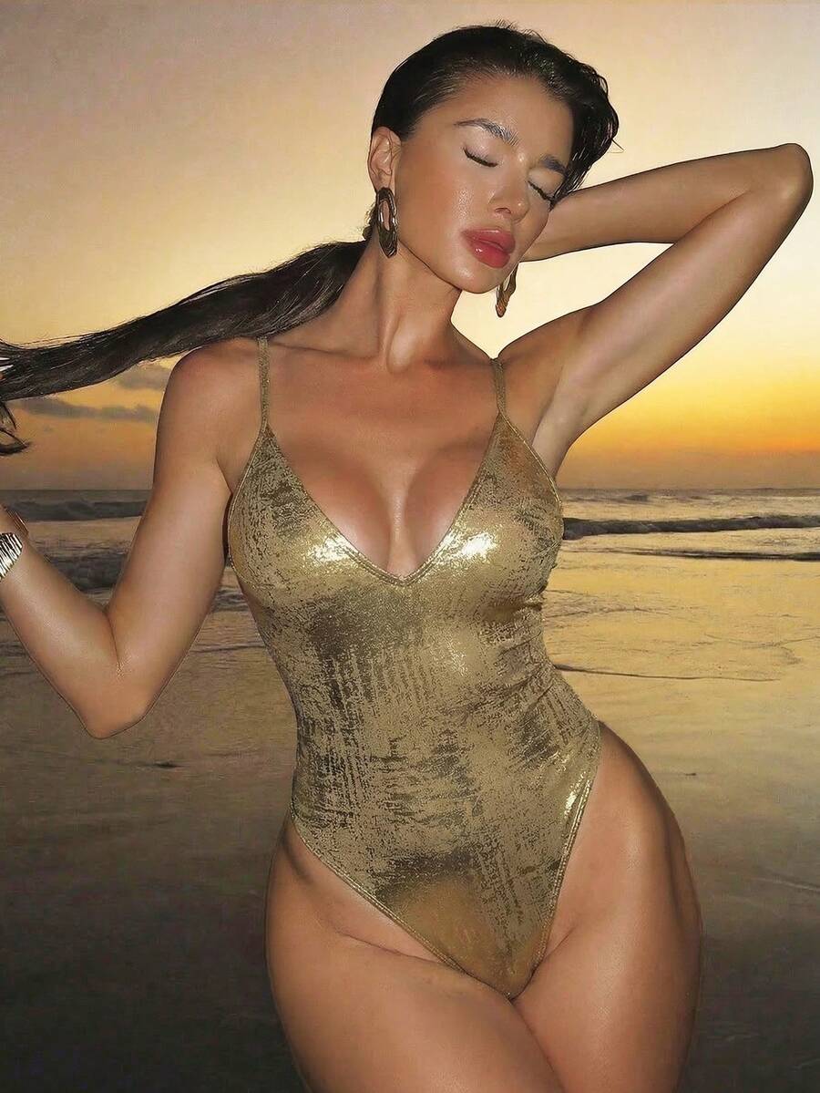 Women's black lace one-piece swimsuit featuring a deep V-neckline, spaghetti straps, backless tie-up detail, and thong bottom.