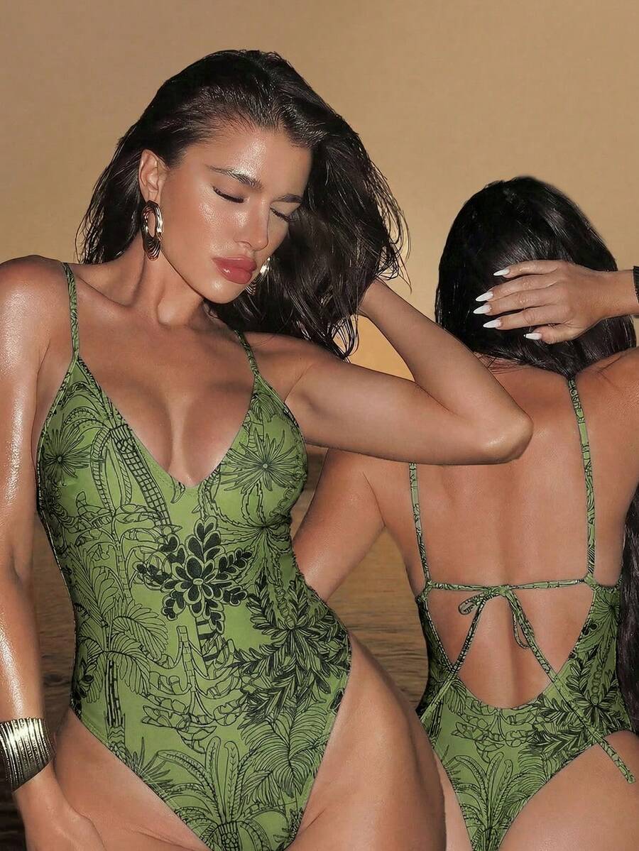Women's black lace one-piece swimsuit featuring a deep V-neckline, spaghetti straps, backless tie-up detail, and thong bottom.