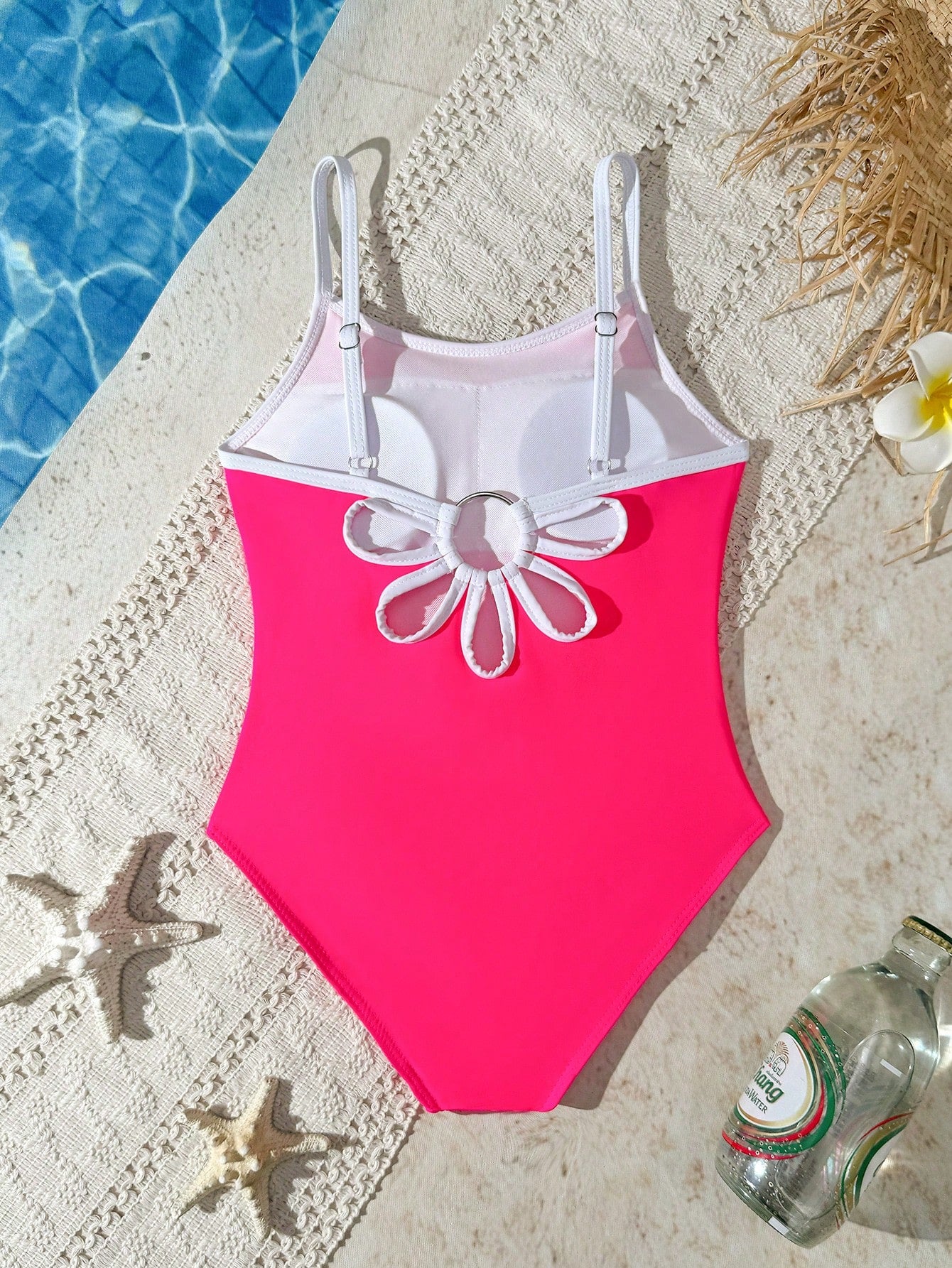 Tween girls one-piece swimsuit with a floral plant print, spaghetti straps, and a mid-waist fit in black.