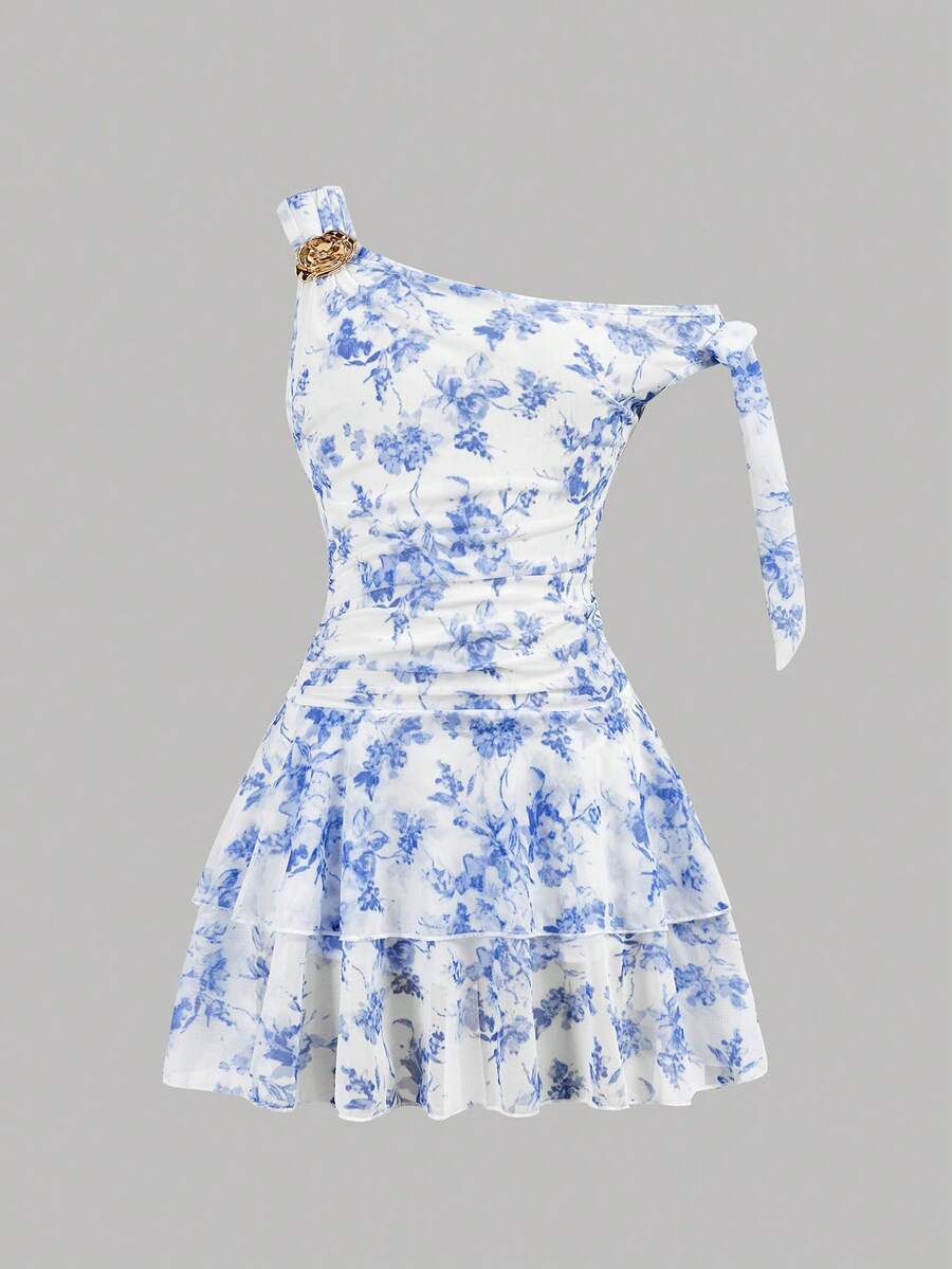 Tween girl wearing an apricot asymmetrical tiered sleeveless party dress with an A-line silhouette.