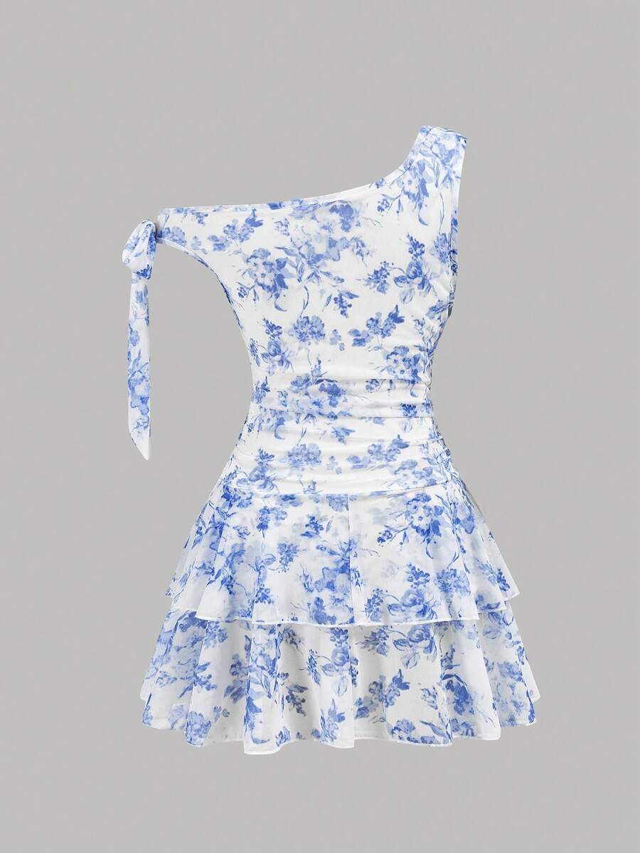 Tween girl wearing an apricot asymmetrical tiered sleeveless party dress with an A-line silhouette.