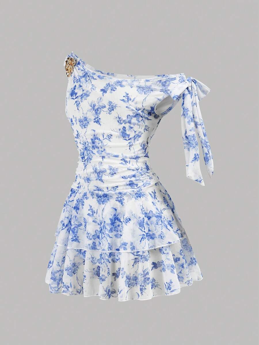 Tween girl wearing an apricot asymmetrical tiered sleeveless party dress with an A-line silhouette.