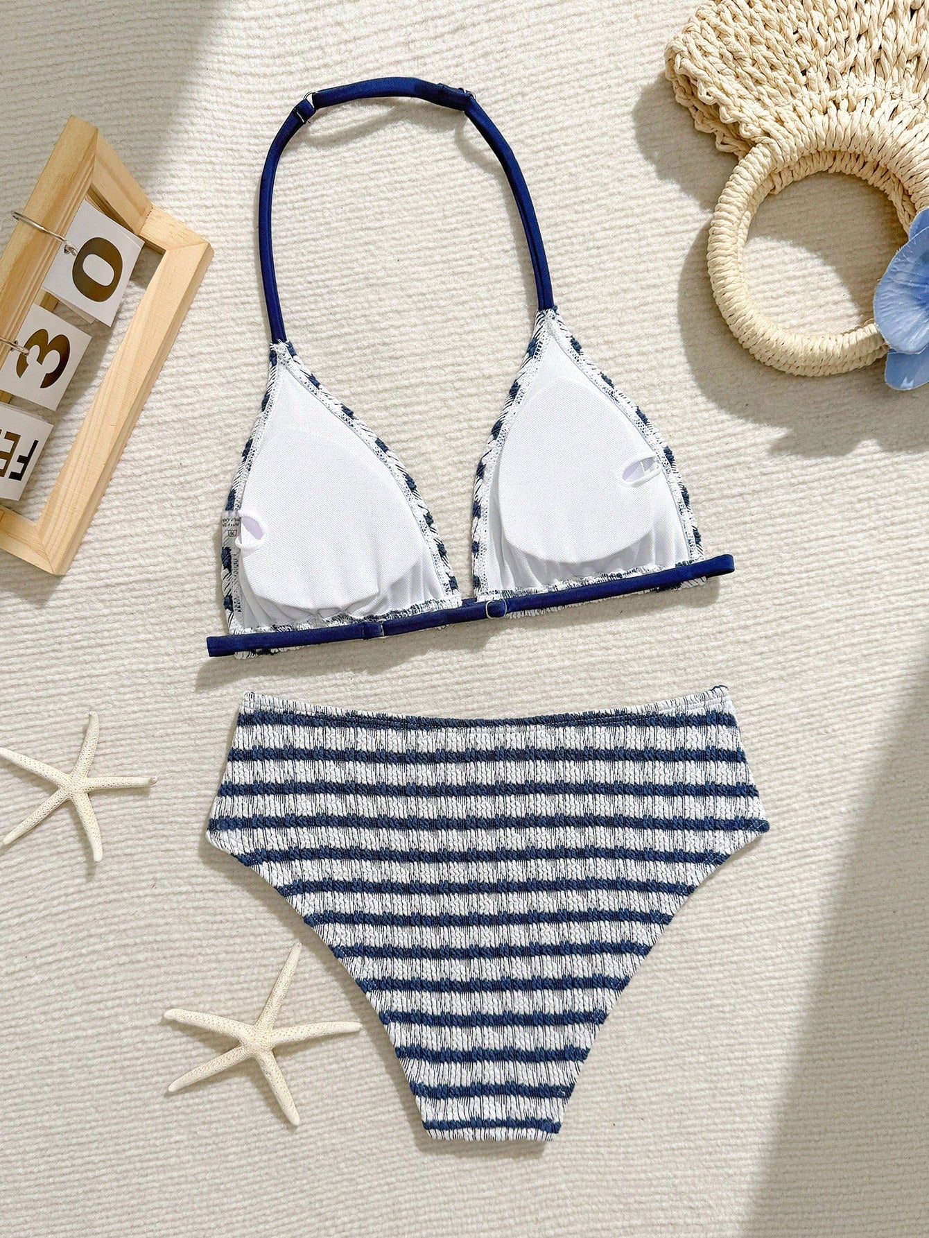 Tween girls blue and white striped two-piece bikini set with halter triangle top and mid-waist short bikini bottoms for beach and vacation swimwear.