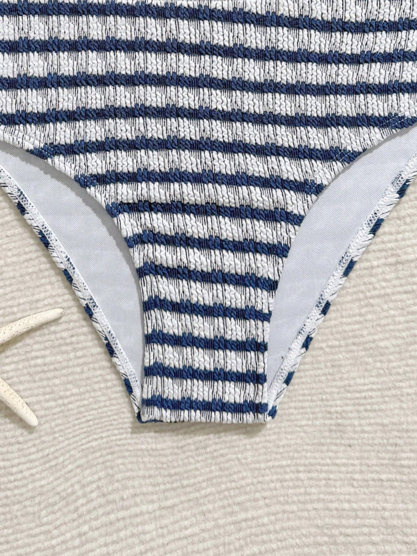 Tween girls blue and white striped two-piece bikini set with halter triangle top and mid-waist short bikini bottoms for beach and vacation swimwear.
