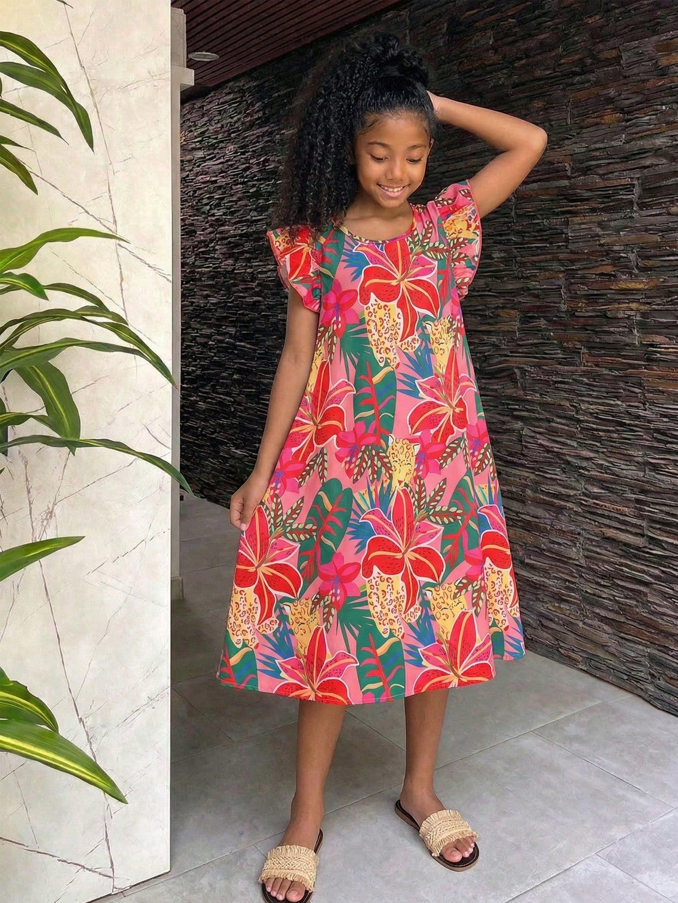 Tween girls sleeveless tropical floral mini dress in black with round neck and ruffle hem detail