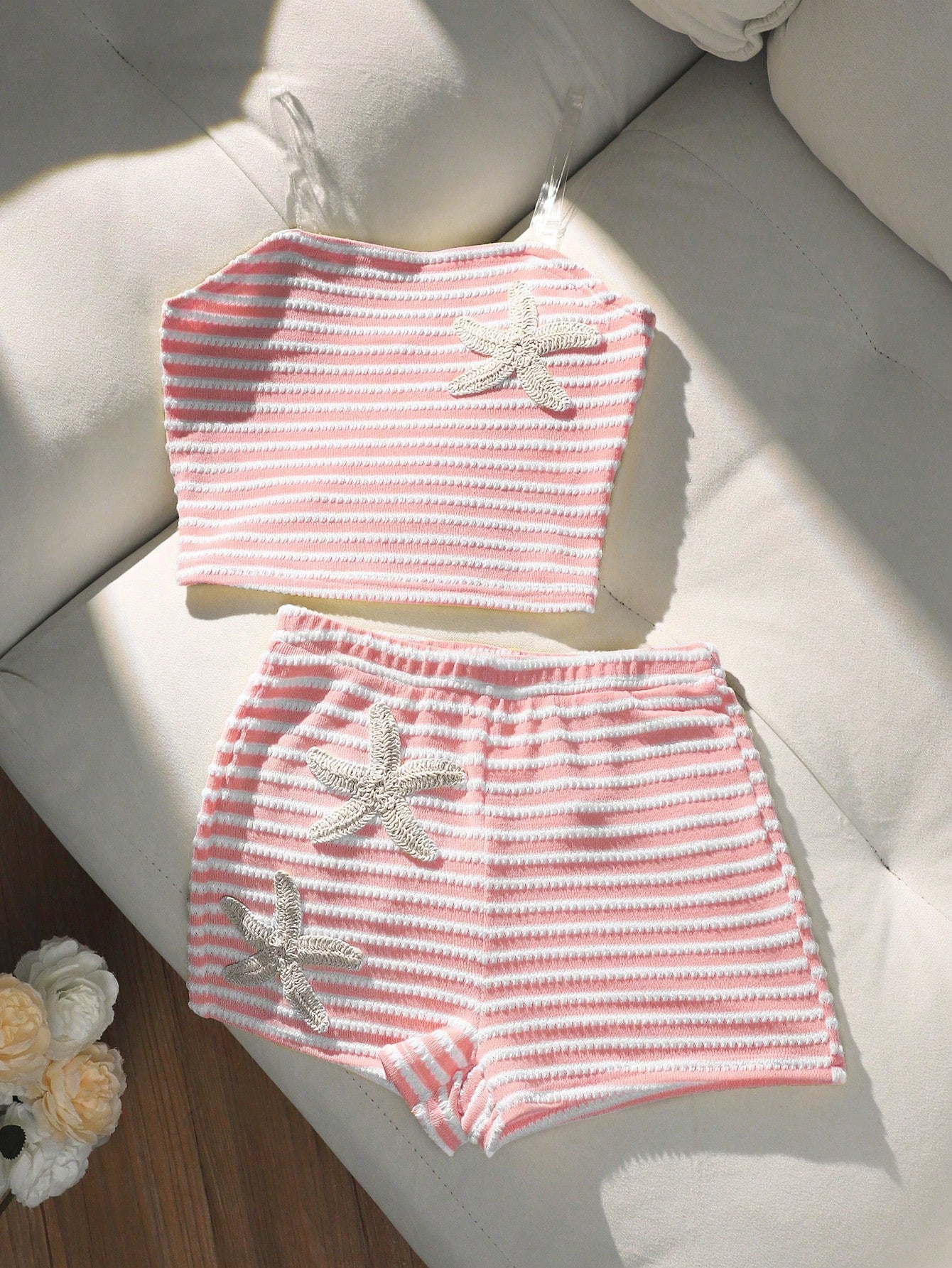 Tween girls black and white striped two-piece set featuring a spaghetti strap micro crop tank top with lettuce trim and ruffle hem paired with matching slim fit shorts.