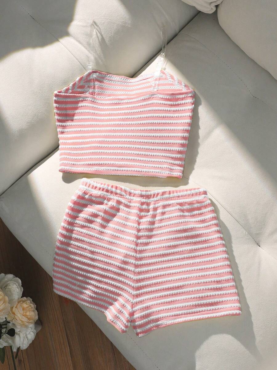 Tween girls black and white striped two-piece set featuring a spaghetti strap micro crop tank top with lettuce trim and ruffle hem paired with matching slim fit shorts.