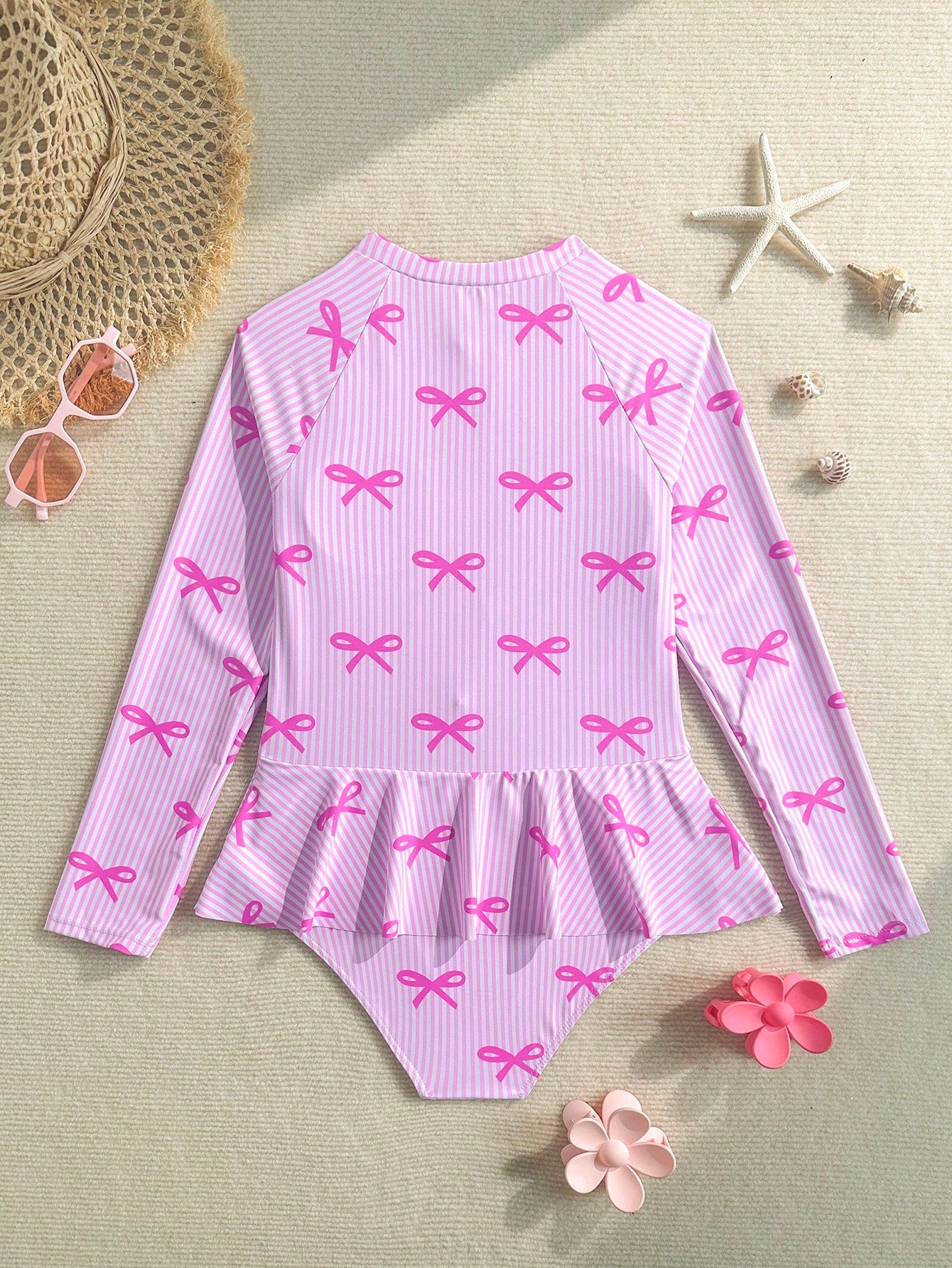 Purple tween girls one-piece swimsuit with graphic striped print, ruffle detail, round neck, and zipper closure for swimming and vacation wear