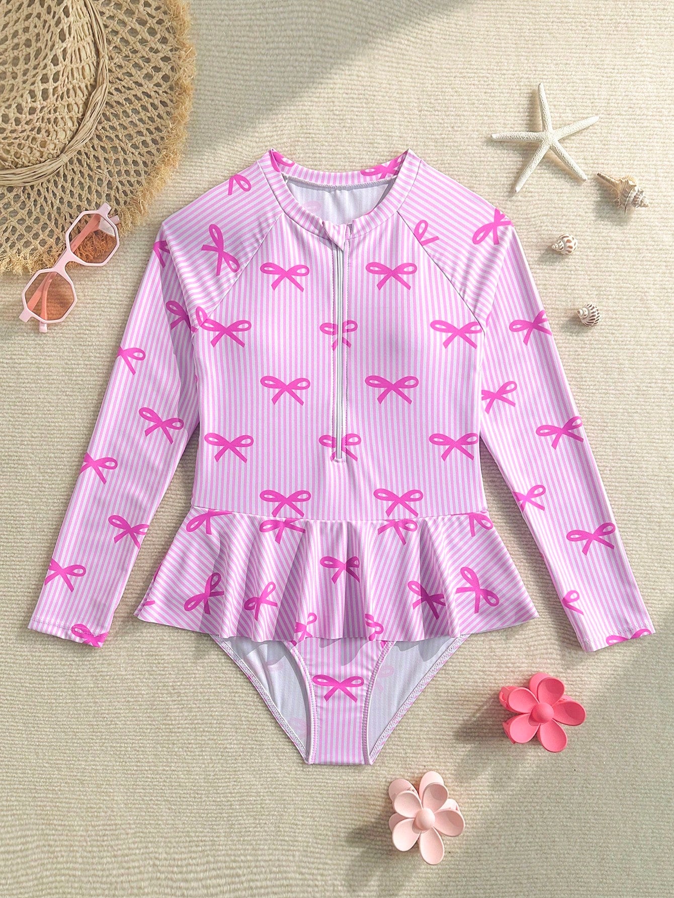 Purple tween girls one-piece swimsuit with graphic striped print, ruffle detail, round neck, and zipper closure for swimming and vacation wear