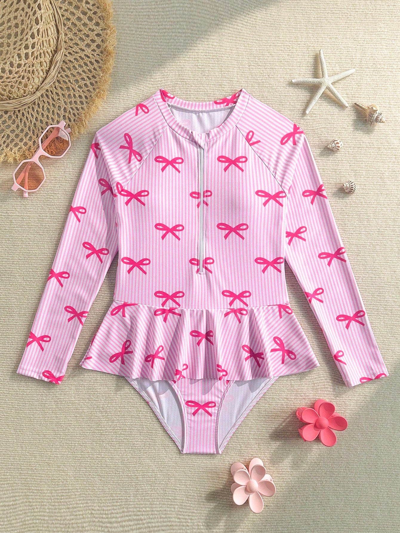 Purple tween girls one-piece swimsuit with graphic striped print, ruffle detail, round neck, and zipper closure for swimming and vacation wear