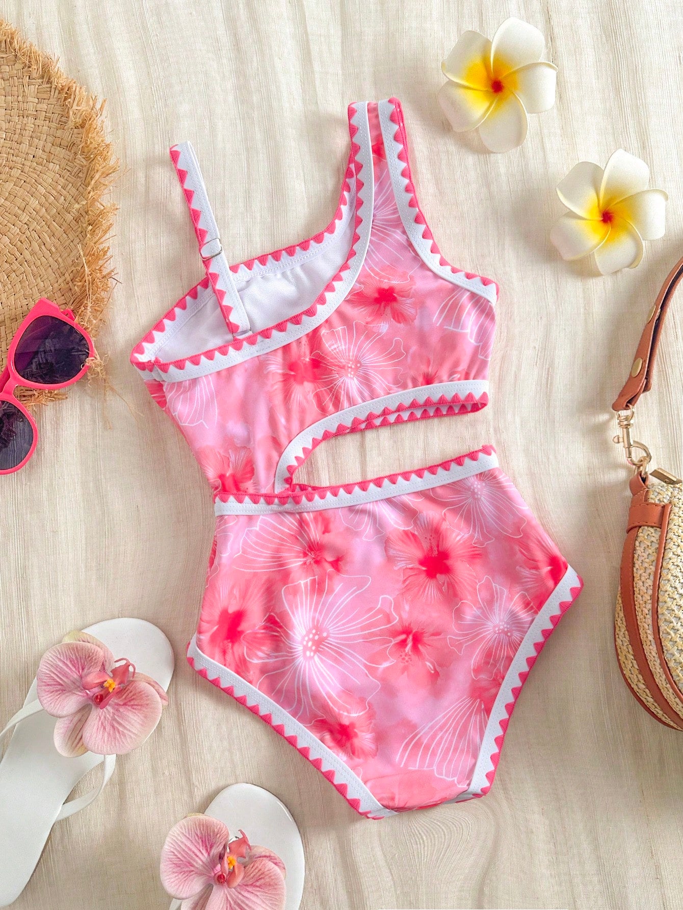 Tween girls one-piece swimsuit featuring an asymmetric neckline, pendant decor, plain design, wireless bra, high-cut bottom, and medium-stretch fabric.