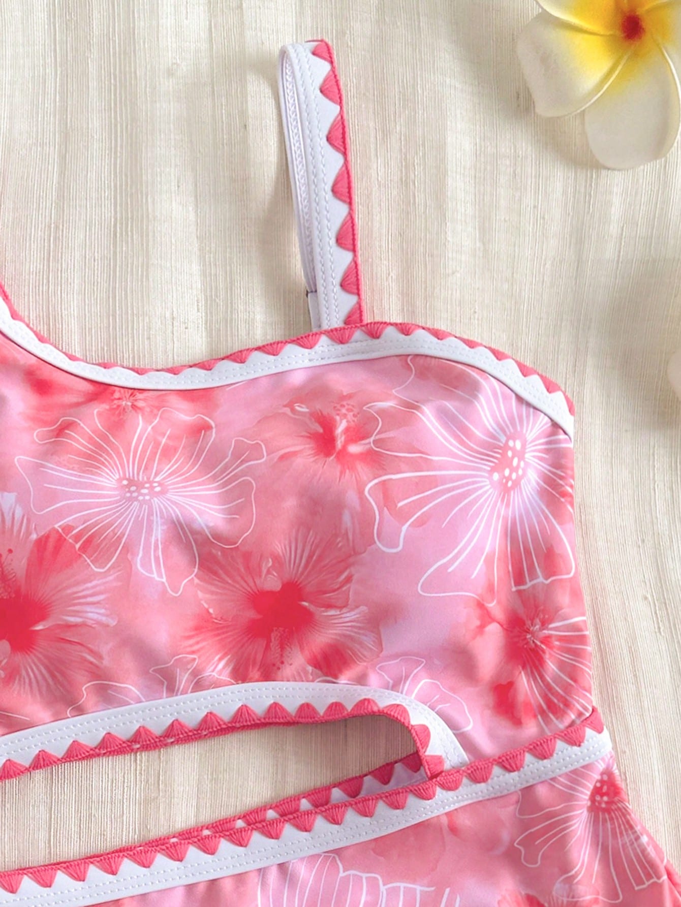 Tween girls one-piece swimsuit featuring an asymmetric neckline, pendant decor, plain design, wireless bra, high-cut bottom, and medium-stretch fabric.