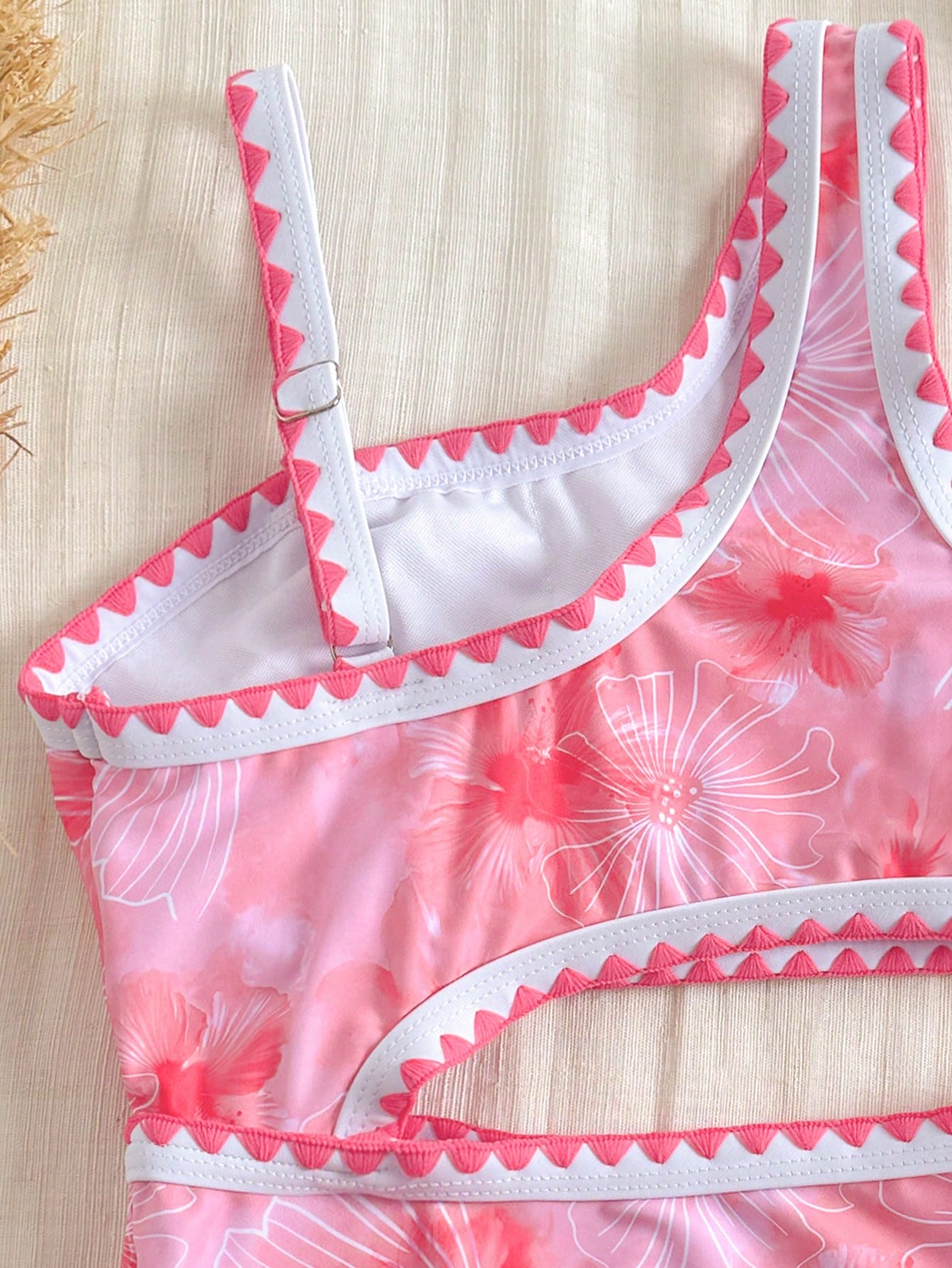 Tween girls one-piece swimsuit featuring an asymmetric neckline, pendant decor, plain design, wireless bra, high-cut bottom, and medium-stretch fabric.