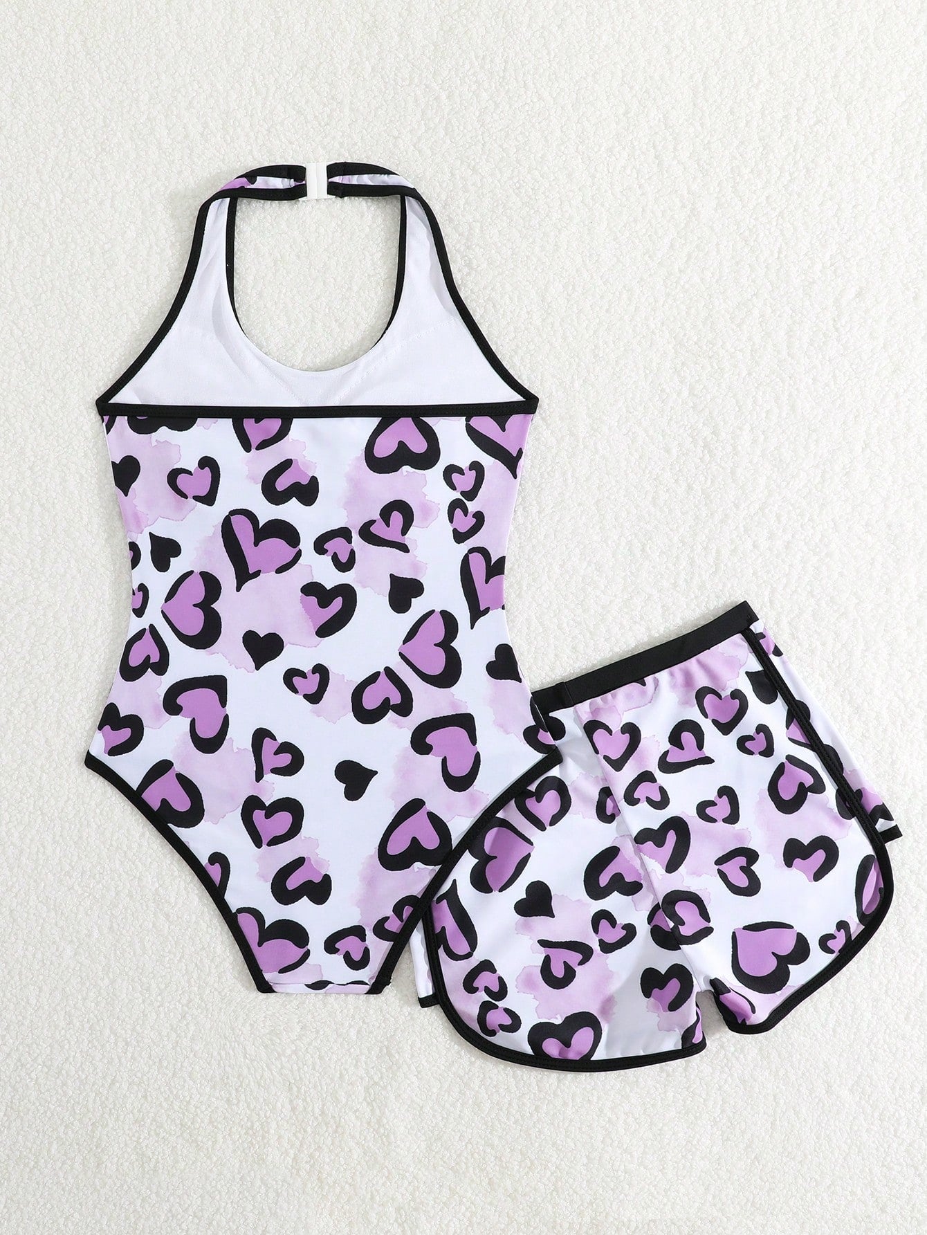 Girls 2-piece swimwear set featuring a butterfly print halter swimsuit top with contrast piping and separate mid-waist shorts; sleeveless, high-stretch, wireless design for beach and vacation wear.