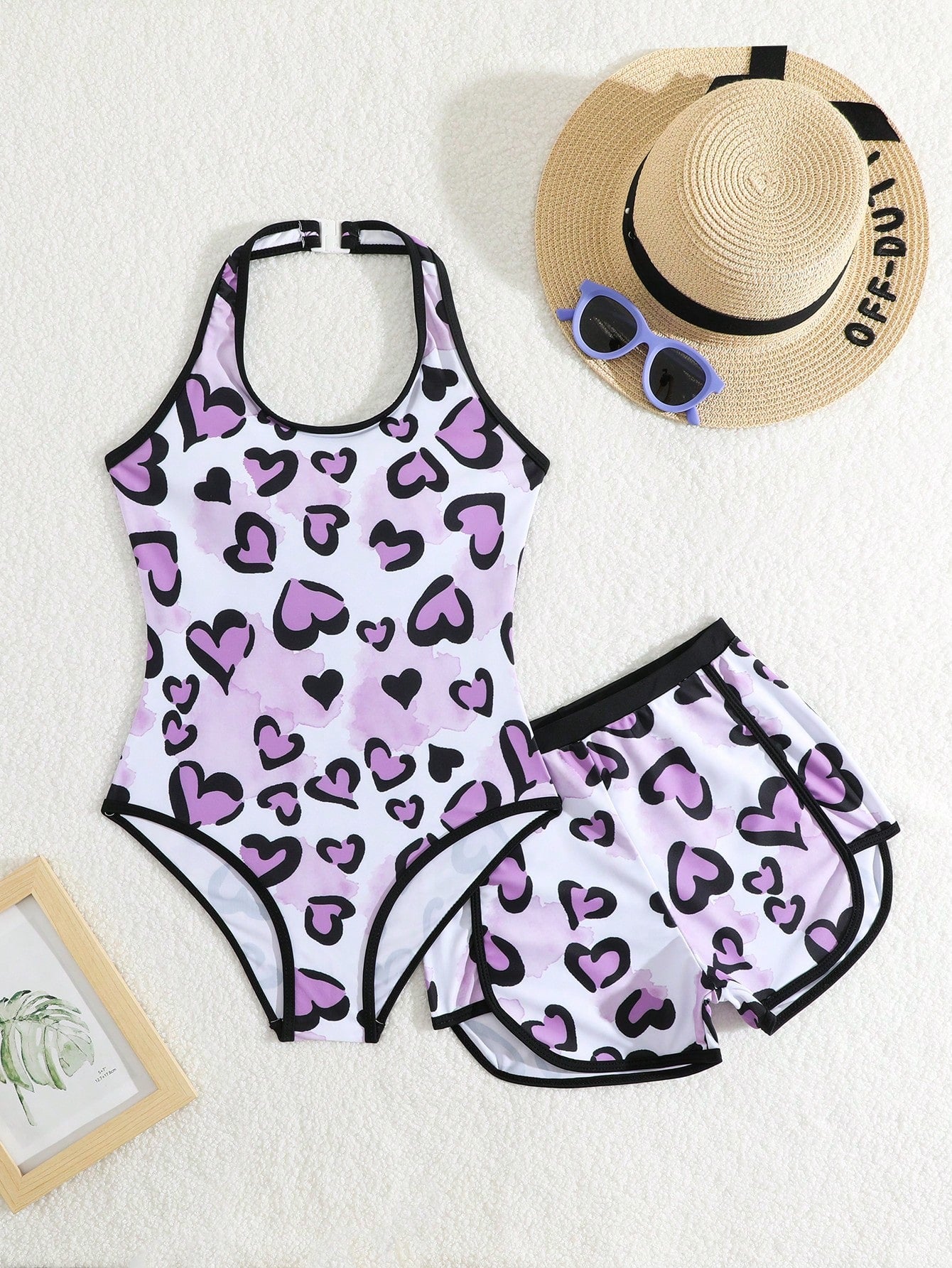 Girls 2-piece swimwear set featuring a butterfly print halter swimsuit top with contrast piping and separate mid-waist shorts; sleeveless, high-stretch, wireless design for beach and vacation wear.