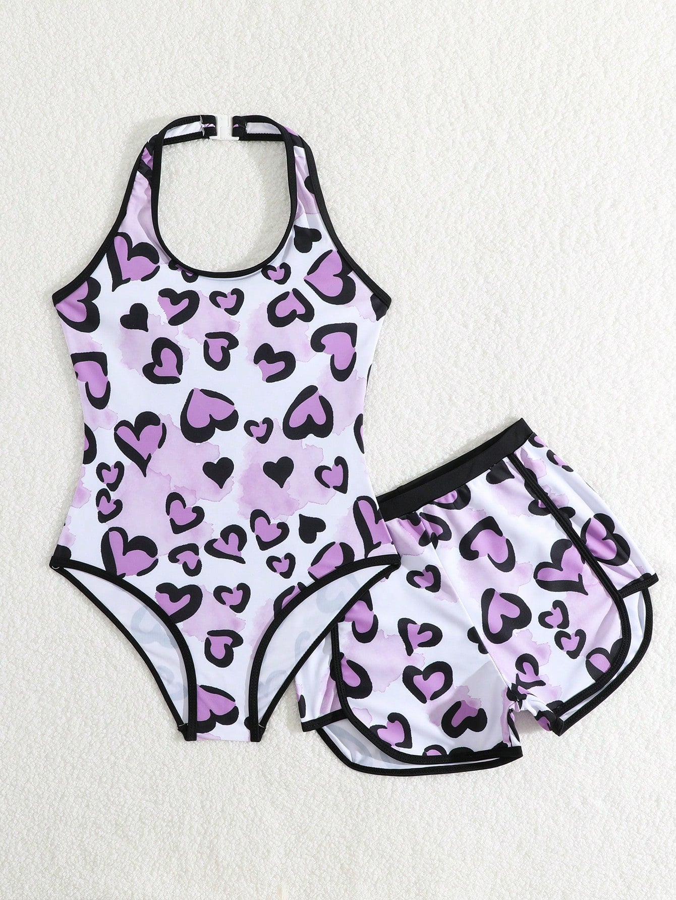 Girls 2-piece swimwear set featuring a butterfly print halter swimsuit top with contrast piping and separate mid-waist shorts; sleeveless, high-stretch, wireless design for beach and vacation wear.