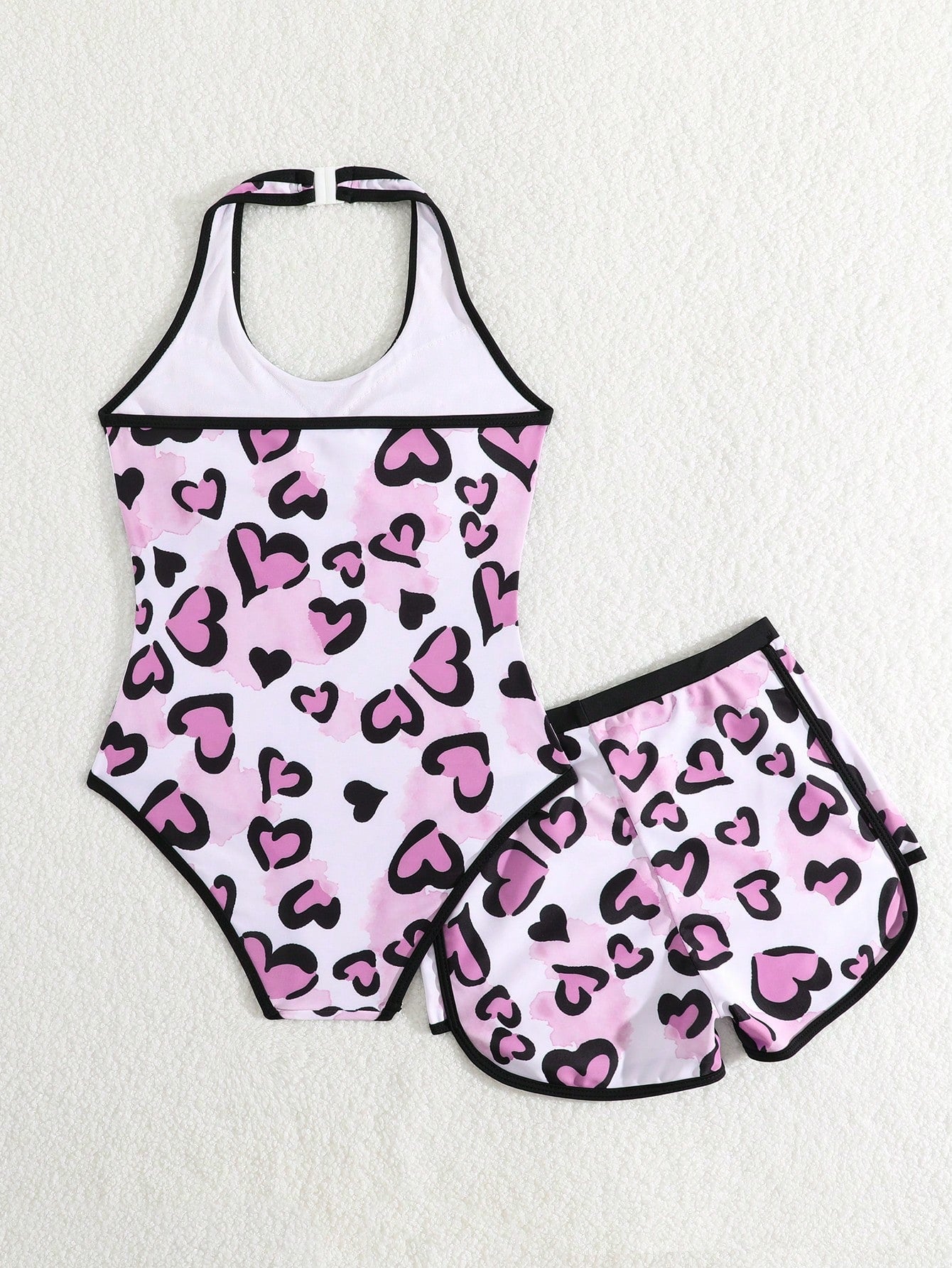 Girls 2-piece swimwear set featuring a butterfly print halter swimsuit top with contrast piping and separate mid-waist shorts; sleeveless, high-stretch, wireless design for beach and vacation wear.