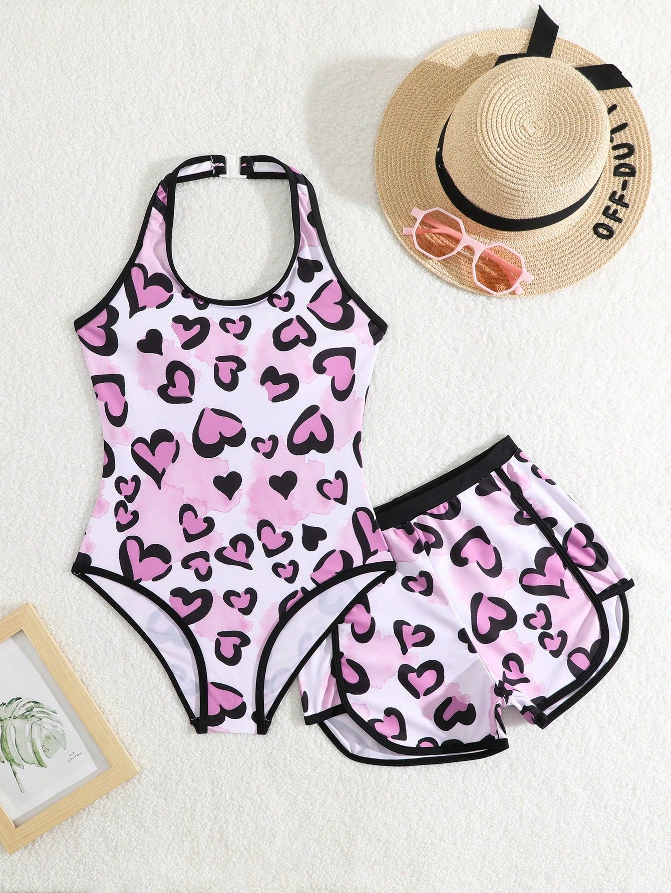 Girls 2-piece swimwear set featuring a butterfly print halter swimsuit top with contrast piping and separate mid-waist shorts; sleeveless, high-stretch, wireless design for beach and vacation wear.