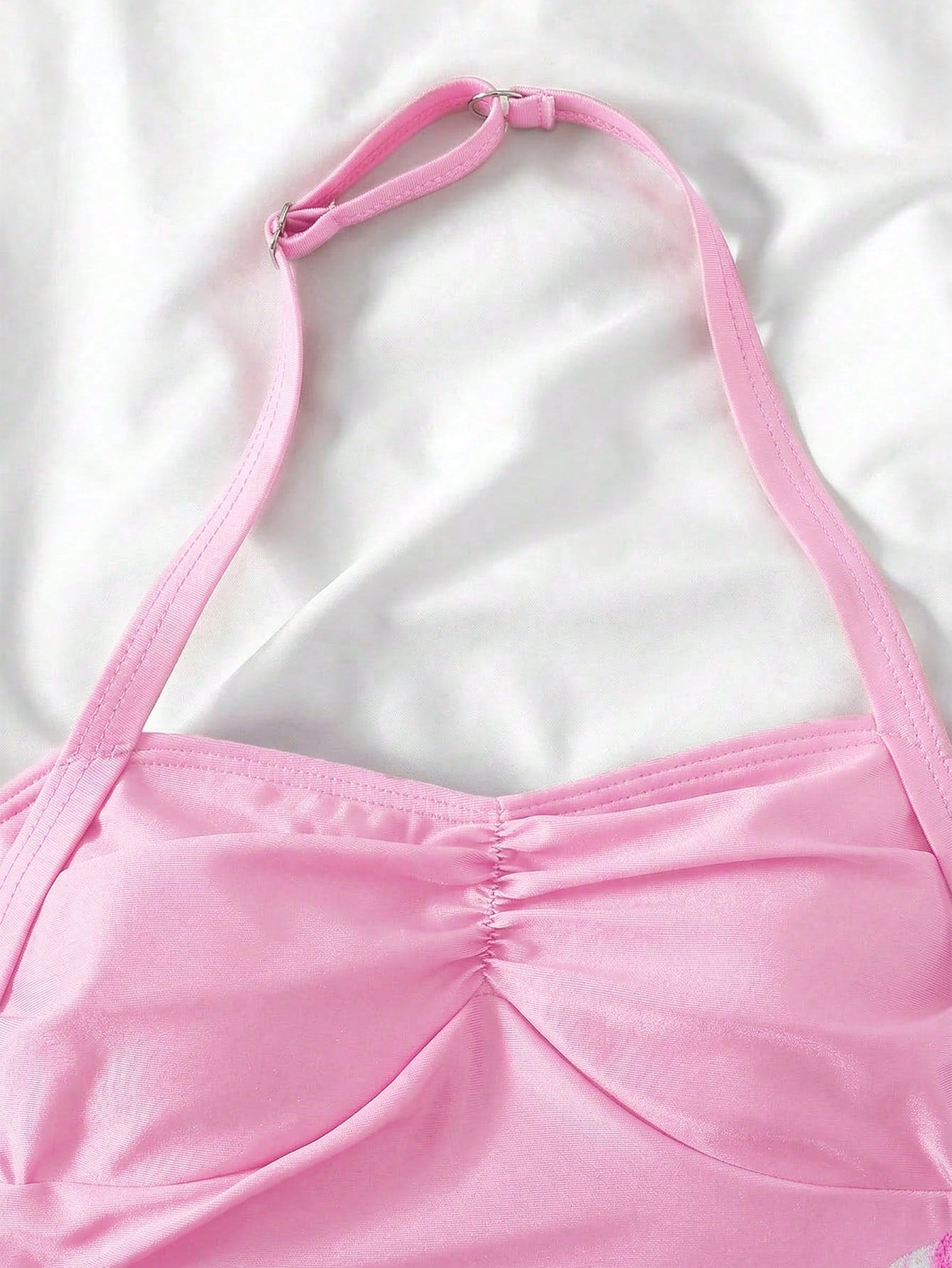Apricot one-piece swimsuit for tween girls with a halter neckline, ruffle trim, textured knit fabric, fitted shape, and starfish metal decor.