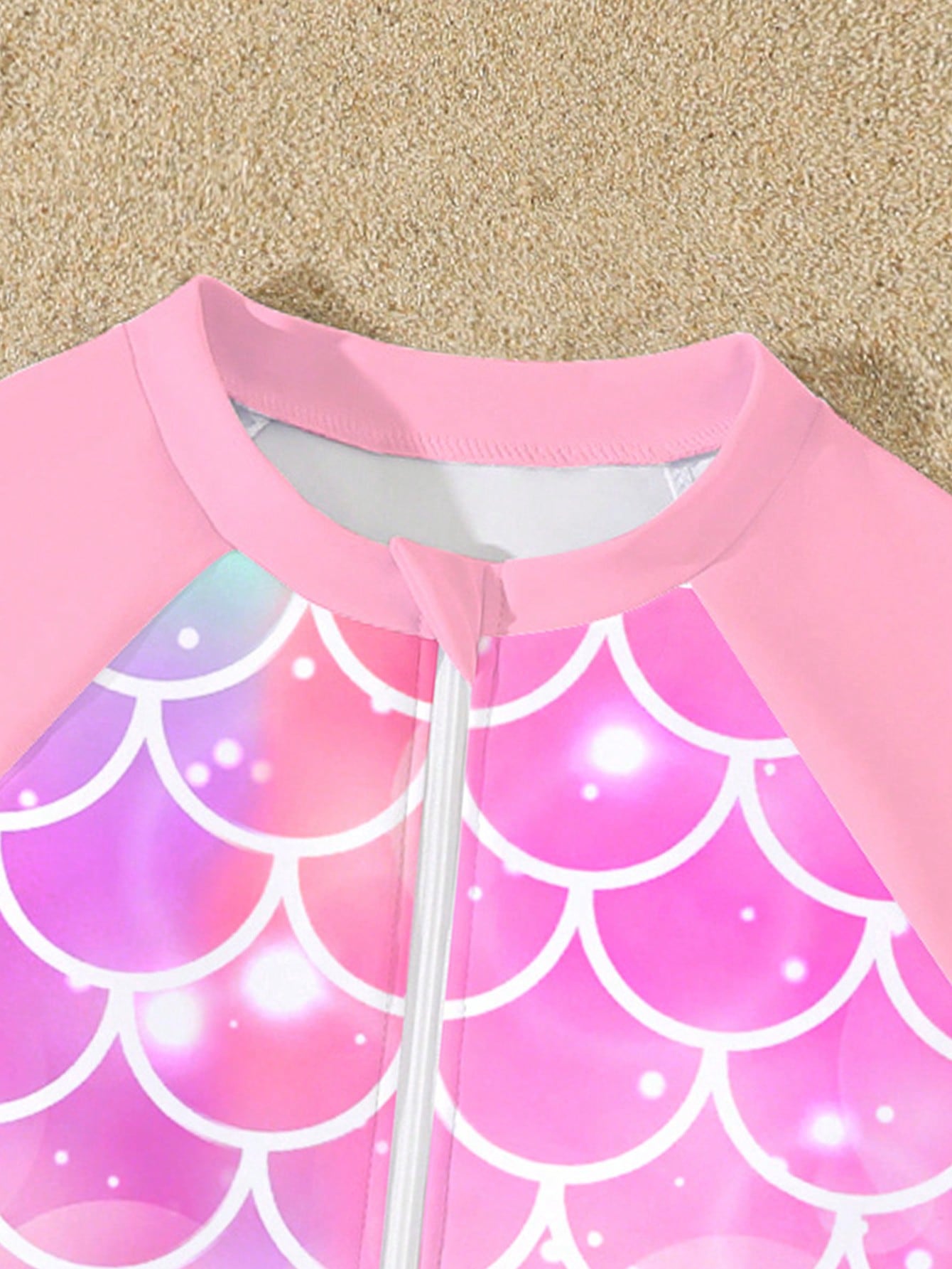 Tween girls one-piece swimsuit featuring a high neck, long sleeves, and shorts bottom, with a back zipper and strawberry plaid digital print on stretch knit fabric. Designed for swimming, vacation, and summer wear.