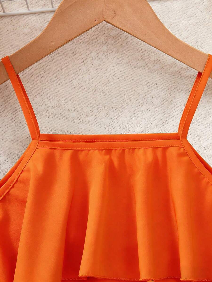 Tween girls blue 2-piece vacation outfit set featuring a tiered ruffle spaghetti strap camisole and loose high-waist pants.