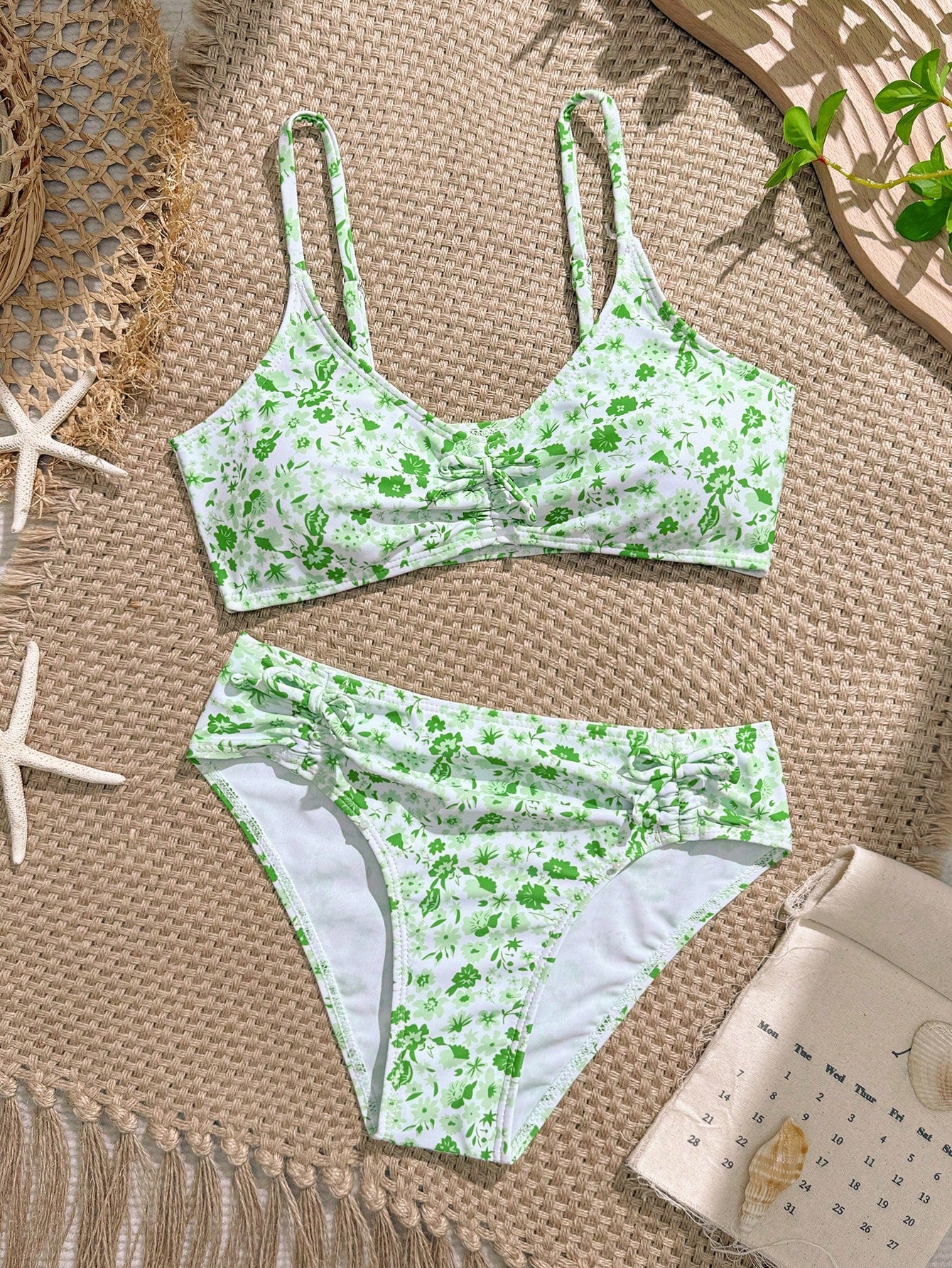Tween girls 2-piece ditsy floral bikini set featuring a spaghetti strap top with center string detail and matching bottoms with side strings, designed for swimming, vacation, and summer wear.