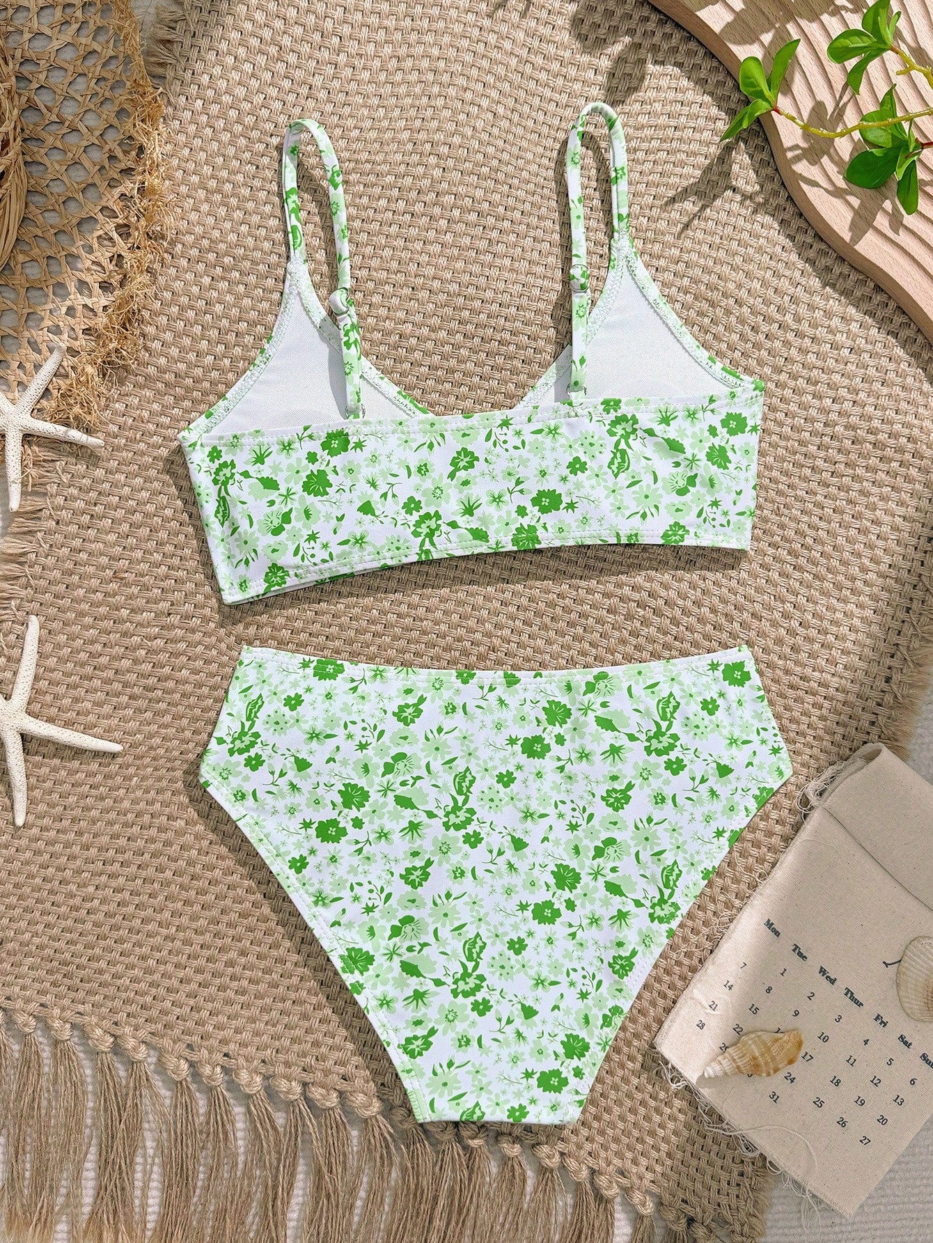 Tween girls 2-piece ditsy floral bikini set featuring a spaghetti strap top with center string detail and matching bottoms with side strings, designed for swimming, vacation, and summer wear.