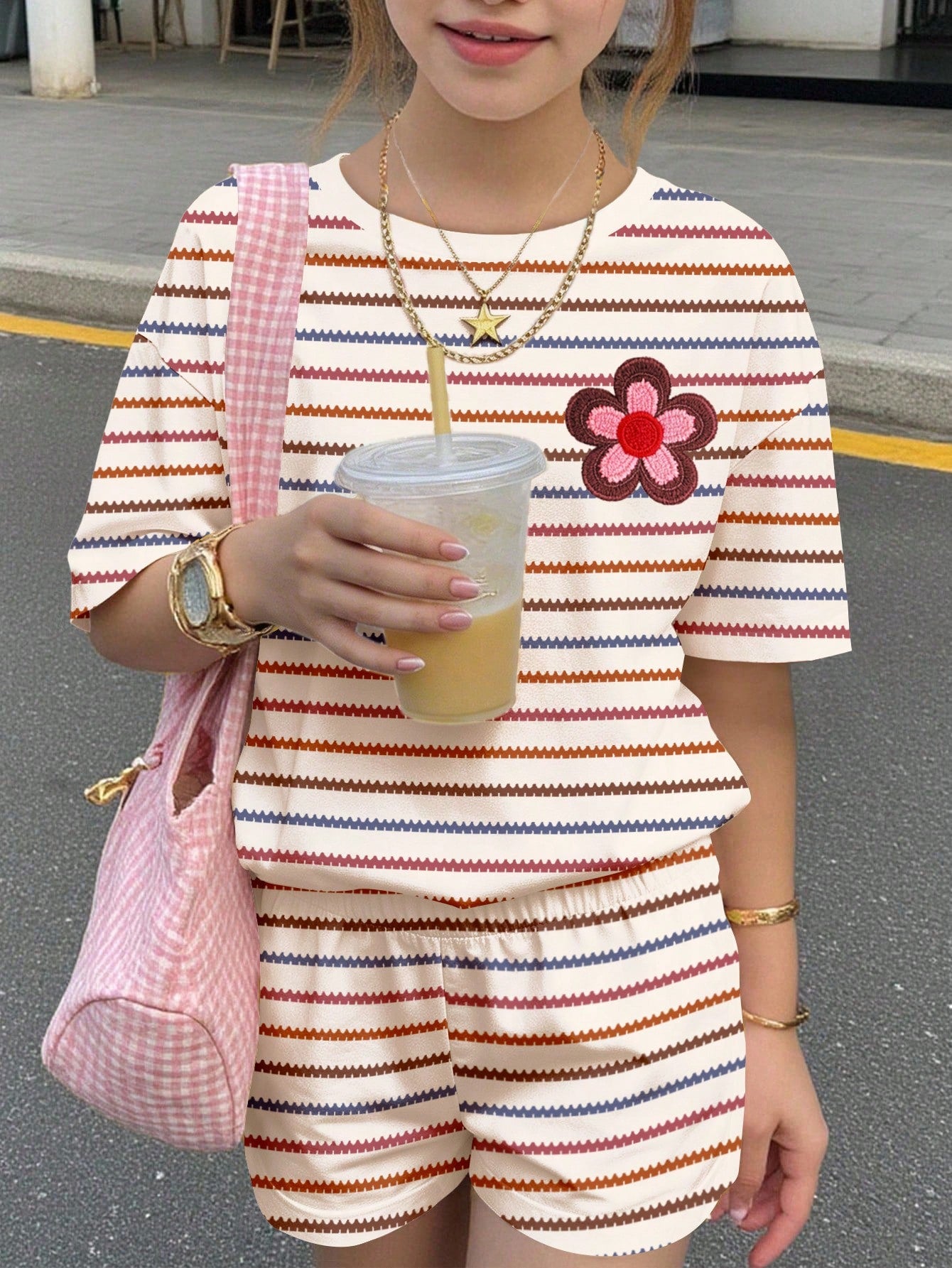 Tween girls multicolor tie-dye 2-piece outfit set featuring a drop-shoulder short-sleeve t-shirt and matching loose track shorts with side pockets.