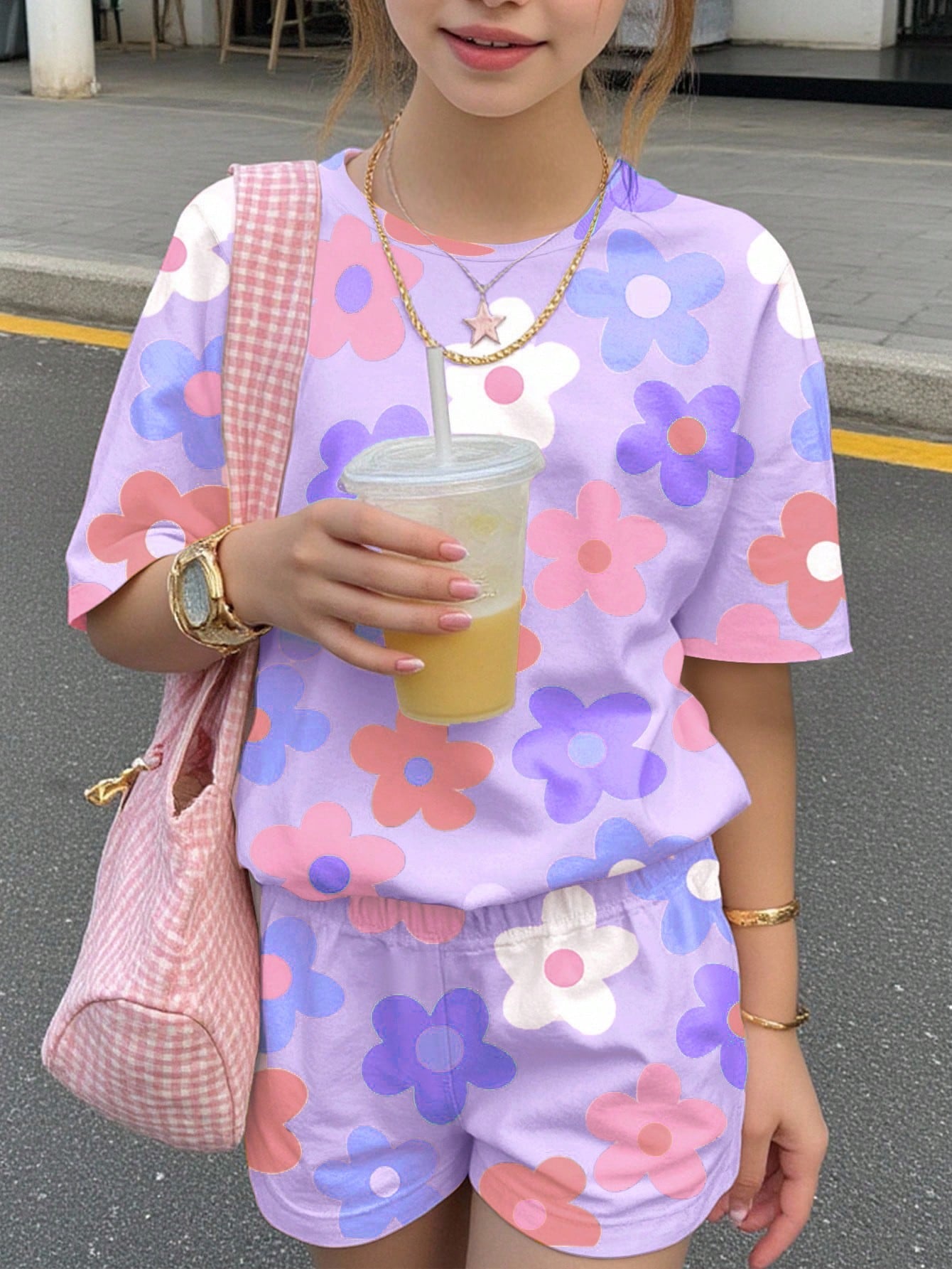 Tween girls multicolor tie-dye 2-piece outfit set featuring a drop-shoulder short-sleeve t-shirt and matching loose track shorts with side pockets.