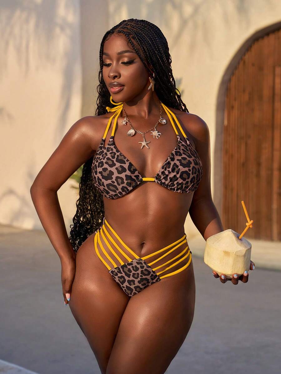 Women's leopard print bikini set featuring a halter push-up top and high-waisted cut out bottoms with tie back detail.