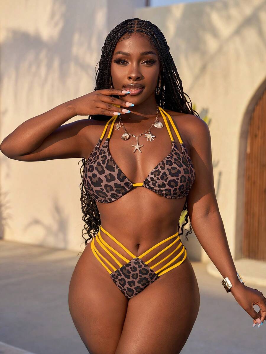 Women's leopard print bikini set featuring a halter push-up top and high-waisted cut out bottoms with tie back detail.