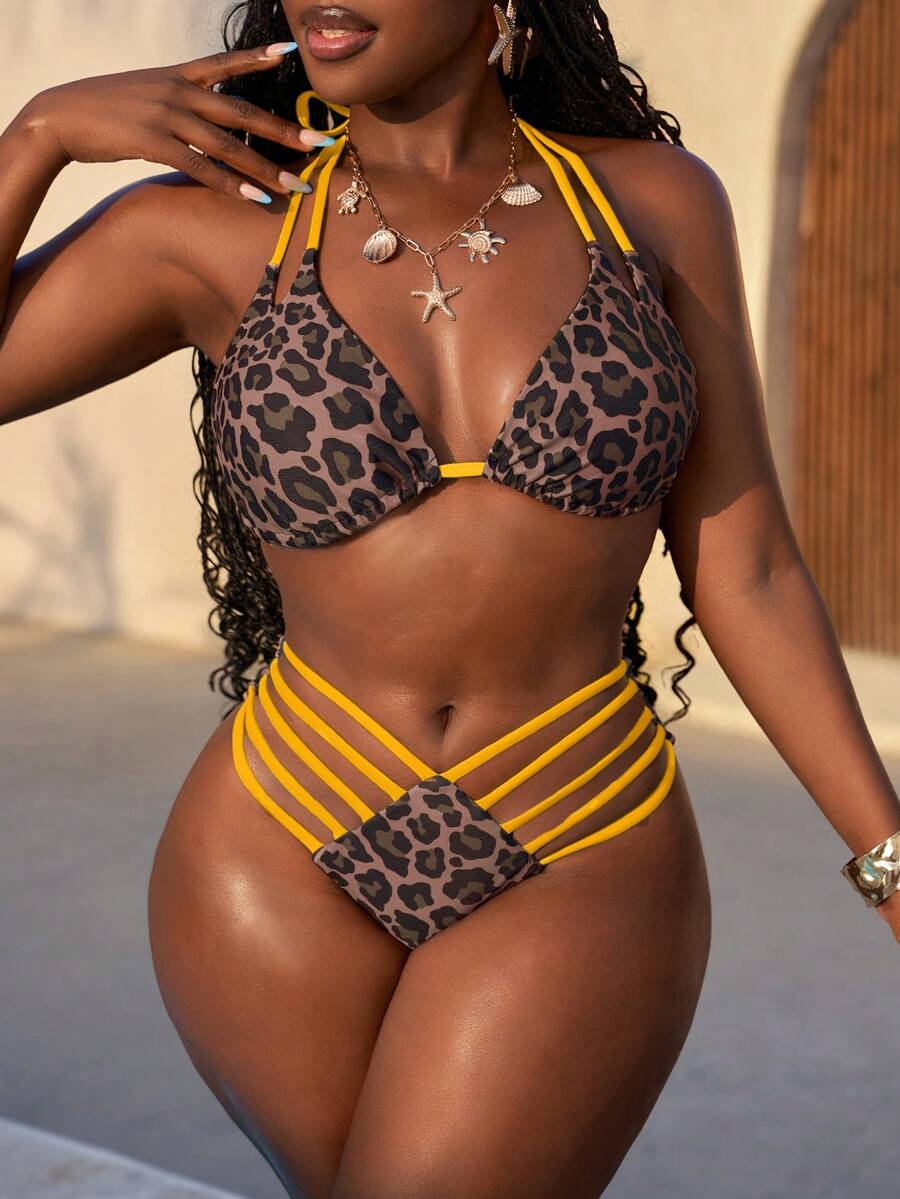 Women's leopard print bikini set featuring a halter push-up top and high-waisted cut out bottoms with tie back detail.