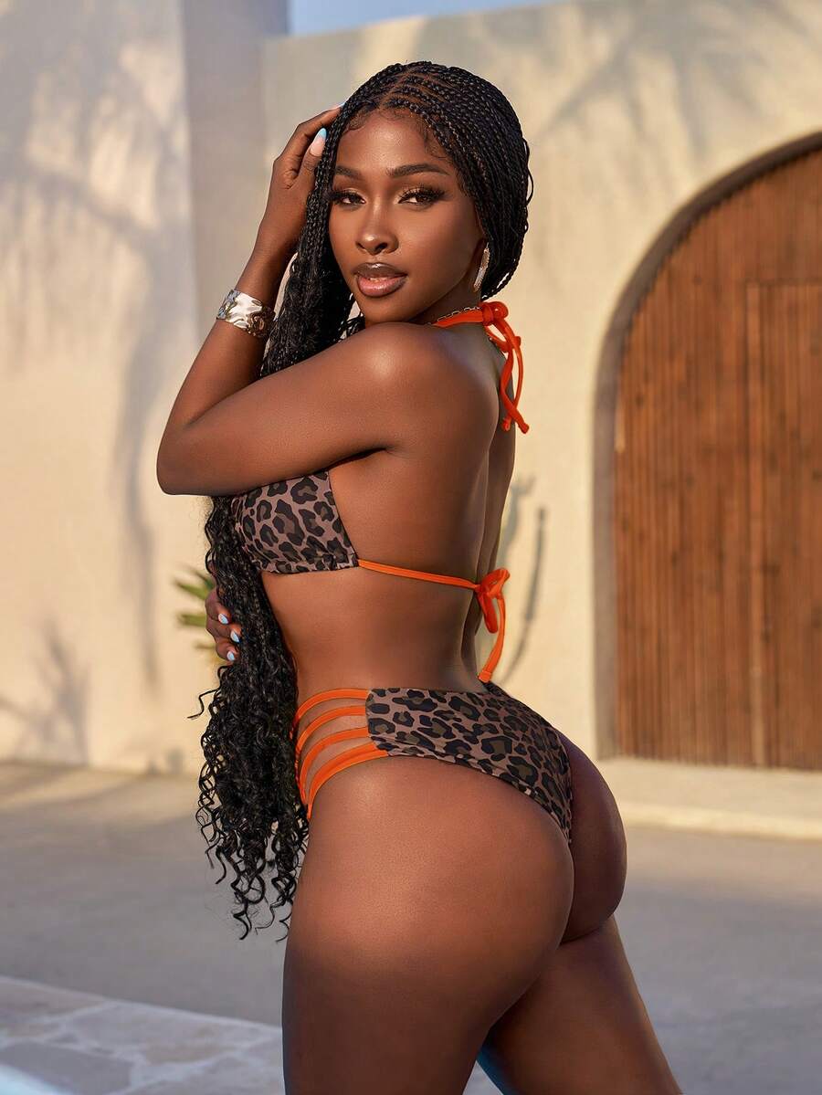 Women's leopard print bikini set featuring a halter push-up top and high-waisted cut out bottoms with tie back detail.