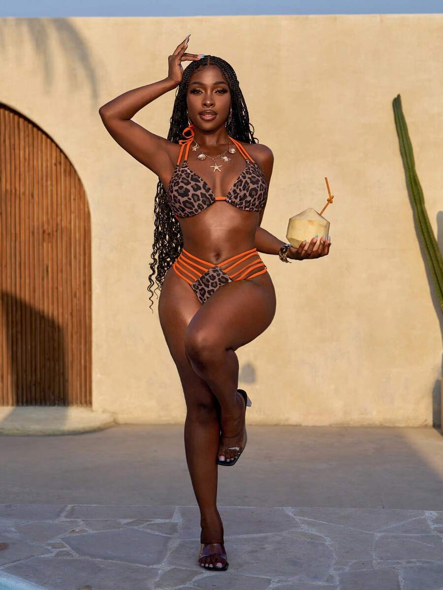 Women's leopard print bikini set featuring a halter push-up top and high-waisted cut out bottoms with tie back detail.