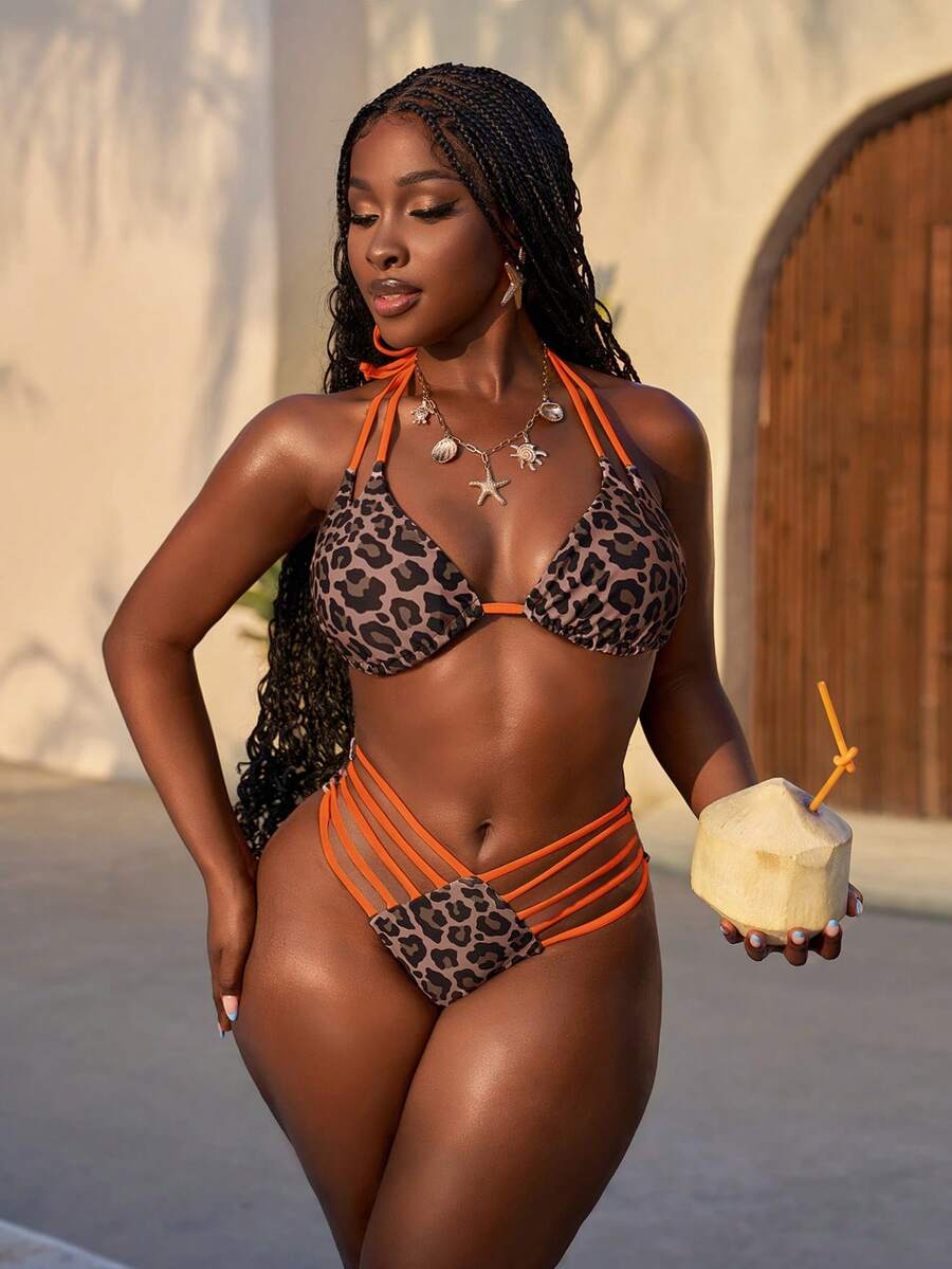 Women's leopard print bikini set featuring a halter push-up top and high-waisted cut out bottoms with tie back detail.