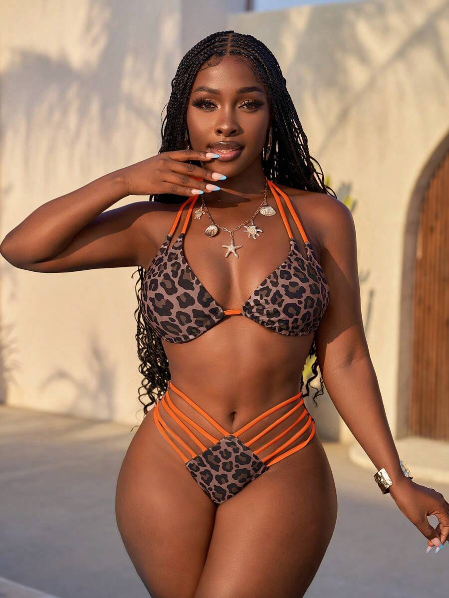Women's leopard print bikini set featuring a halter push-up top and high-waisted cut out bottoms with tie back detail.